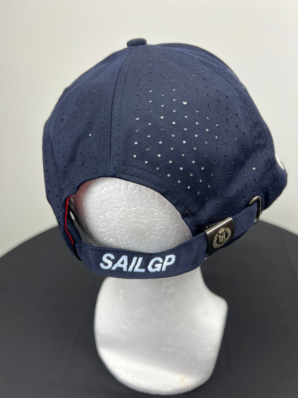 Back view of navy blue cap with adjustable strap branded Sail GP and metal clasp