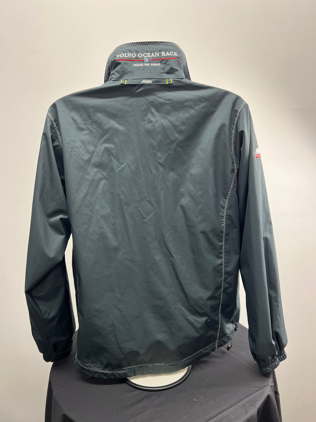 Back view of Women’s Musto Volvo Ocean Race jacket showing clean dark grey fabric and logo on collar