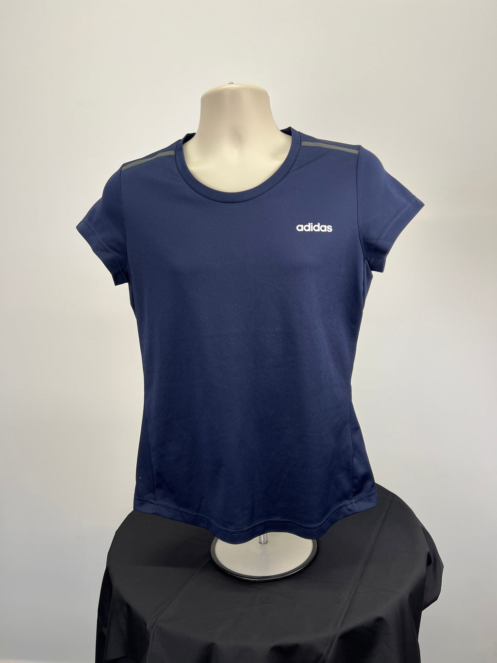 Front view of women's navy Adidas performance t-shirt with white logo on chest