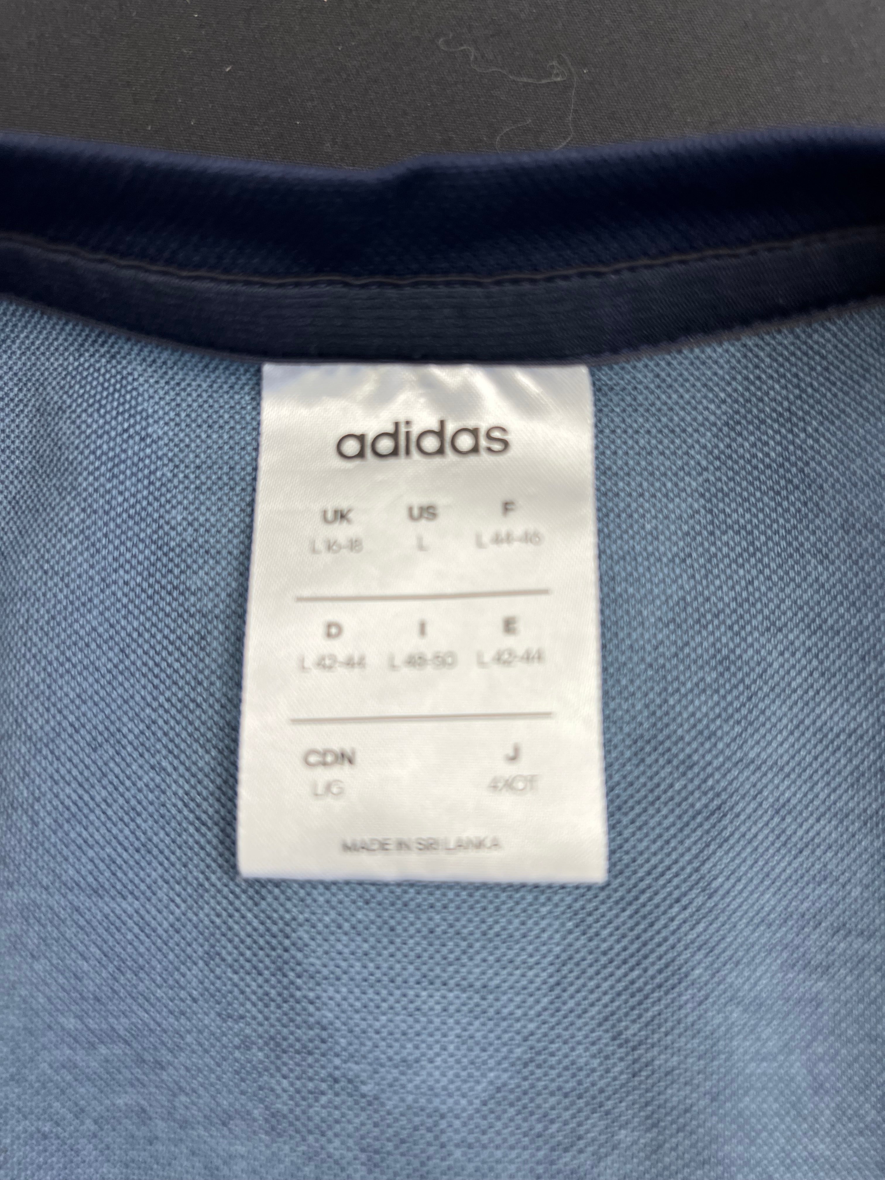 Close-up of Adidas size label inside the t-shirt showing UK size 16-18