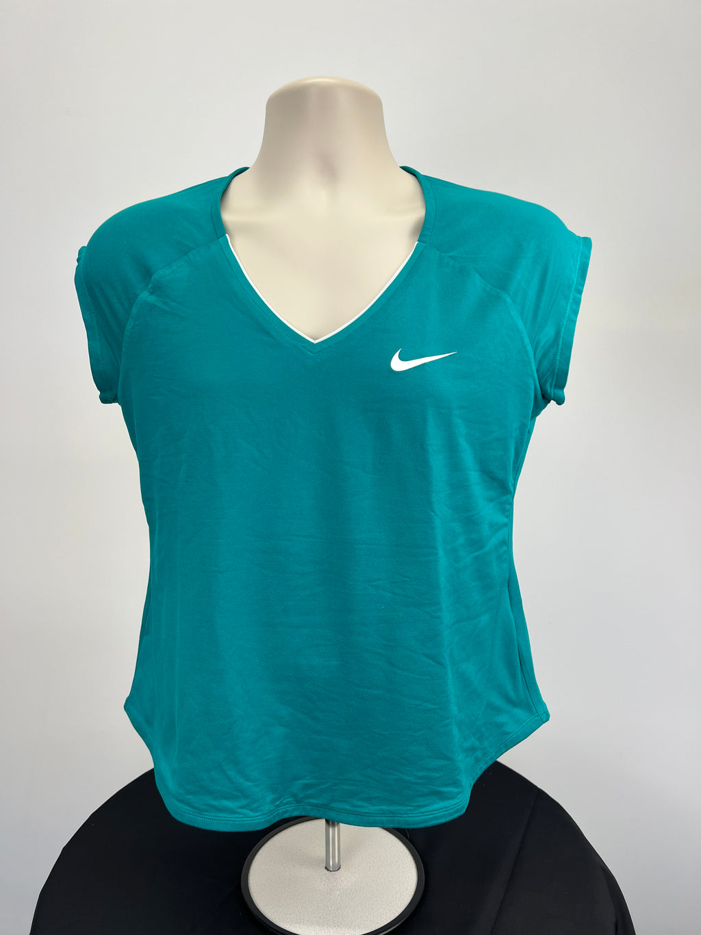 Front view of Nike women’s teal V neck t-shirt on mannequin