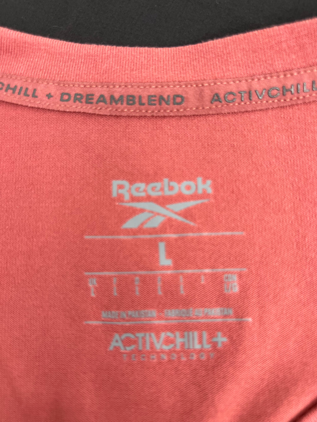 Close-up of Reebok label and Activchill technology printing inside the neckline of the t-shirt