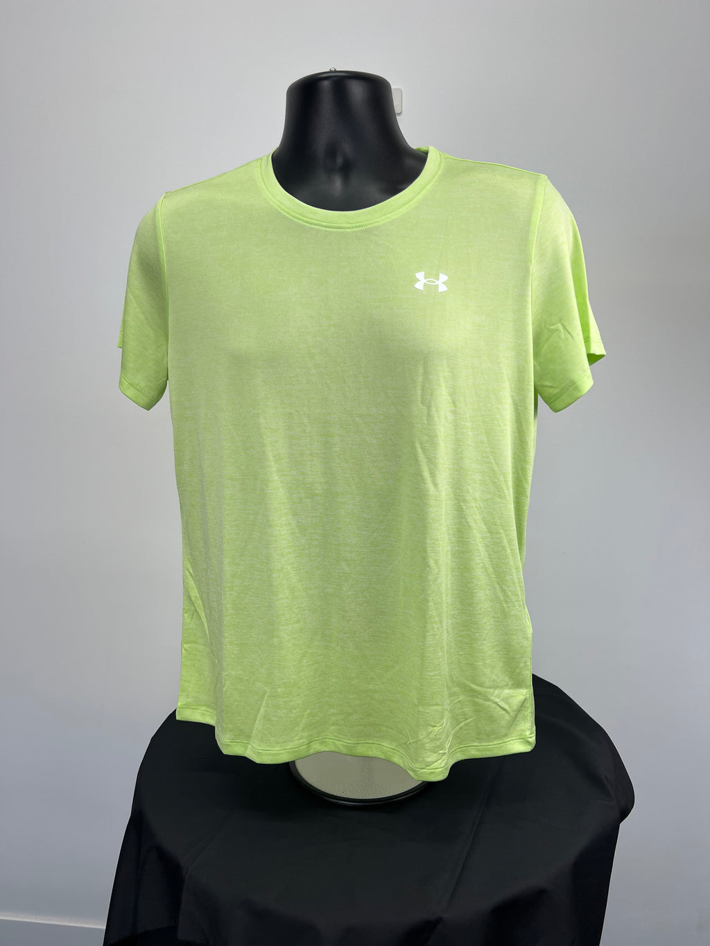 Front view of Under Armour loose fitting neon green T-shirt on black mannequin