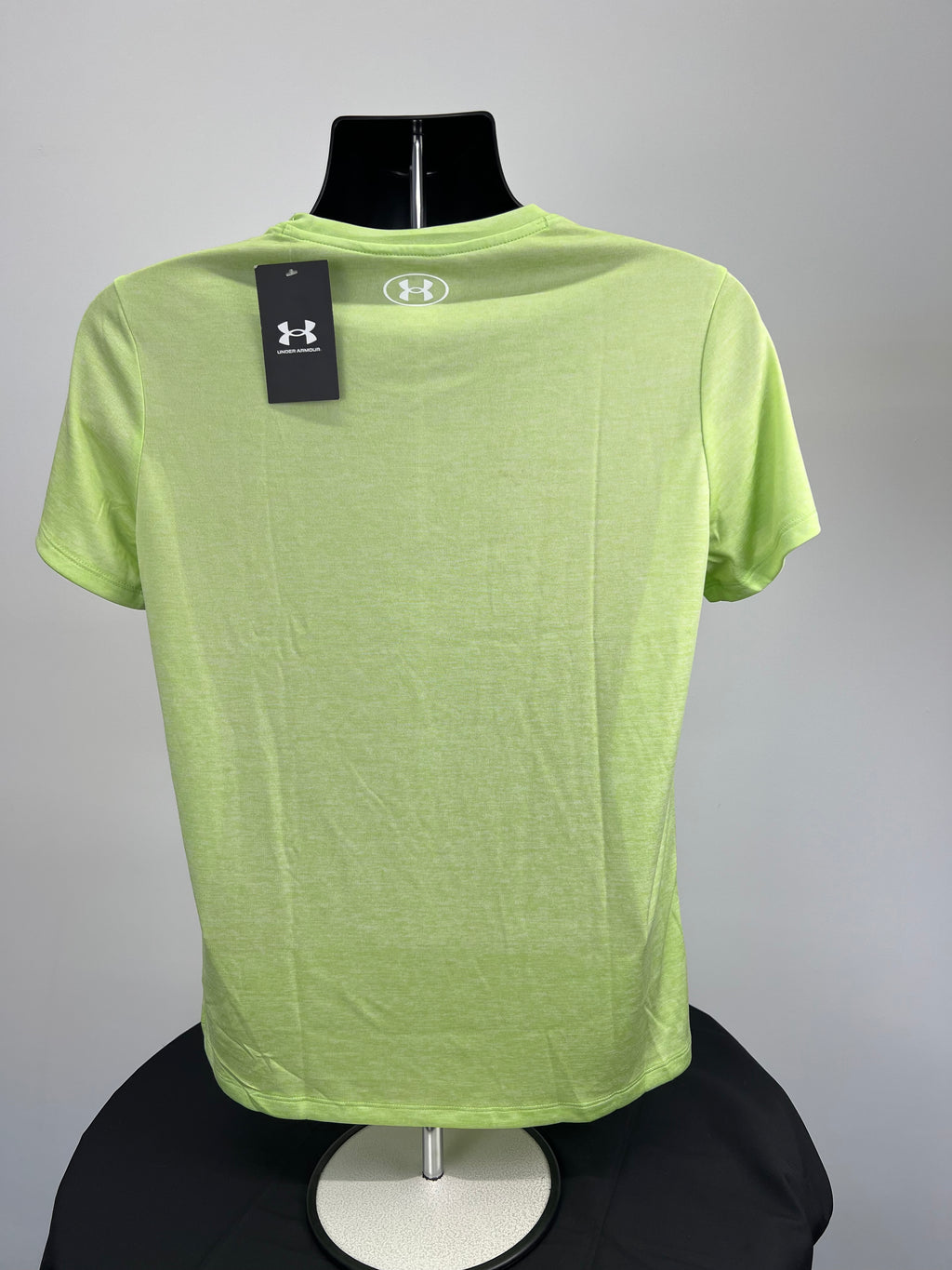 Back view of Under Armour loose fitting neon green T-shirt showing logo on collar