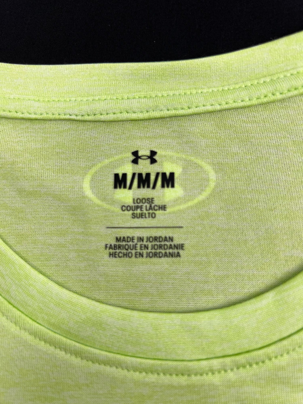Close-up of inside collar label showing size M and 'Loose' fit description