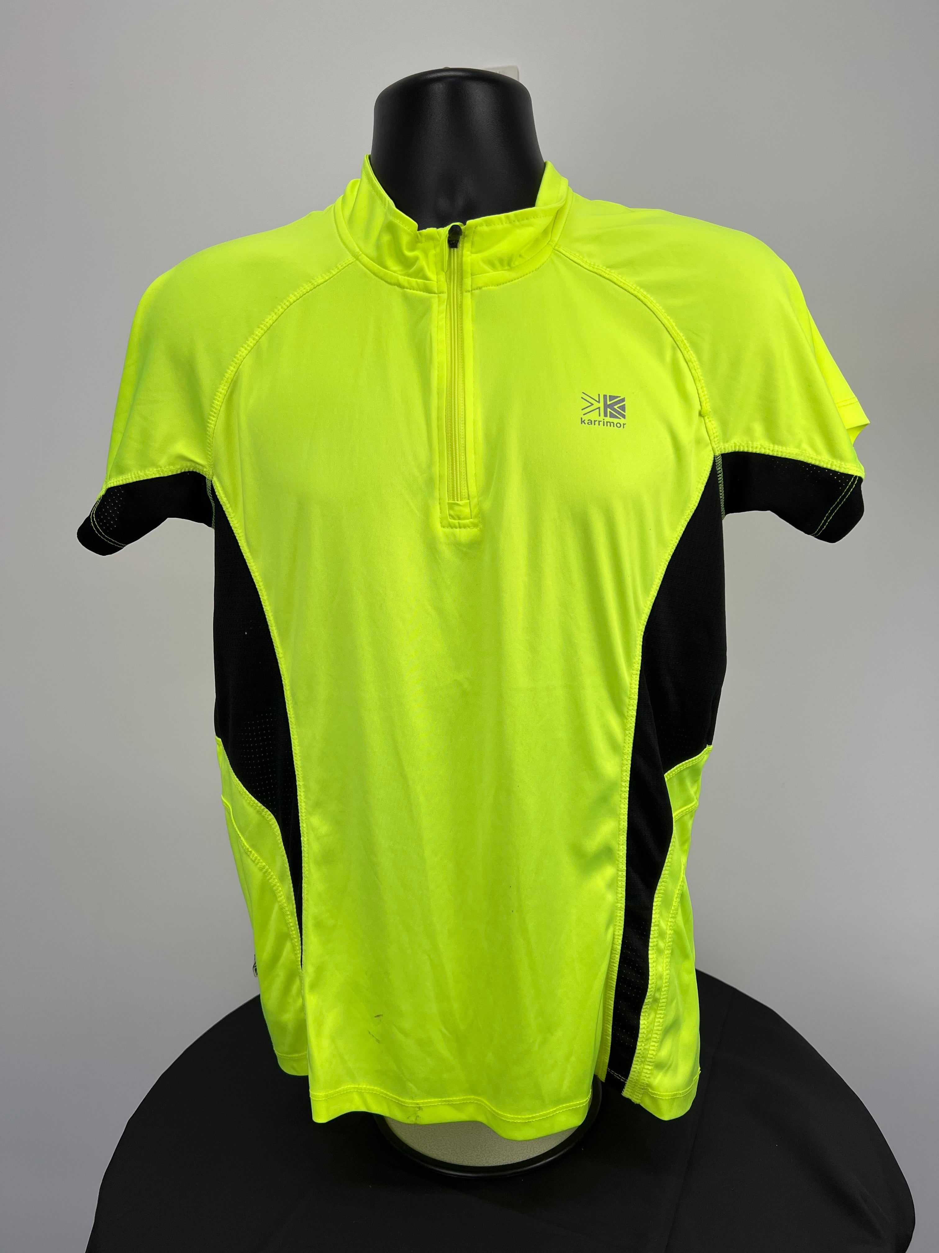 Front view of bright green Karrimor run 1/2 zip top with black side panels
