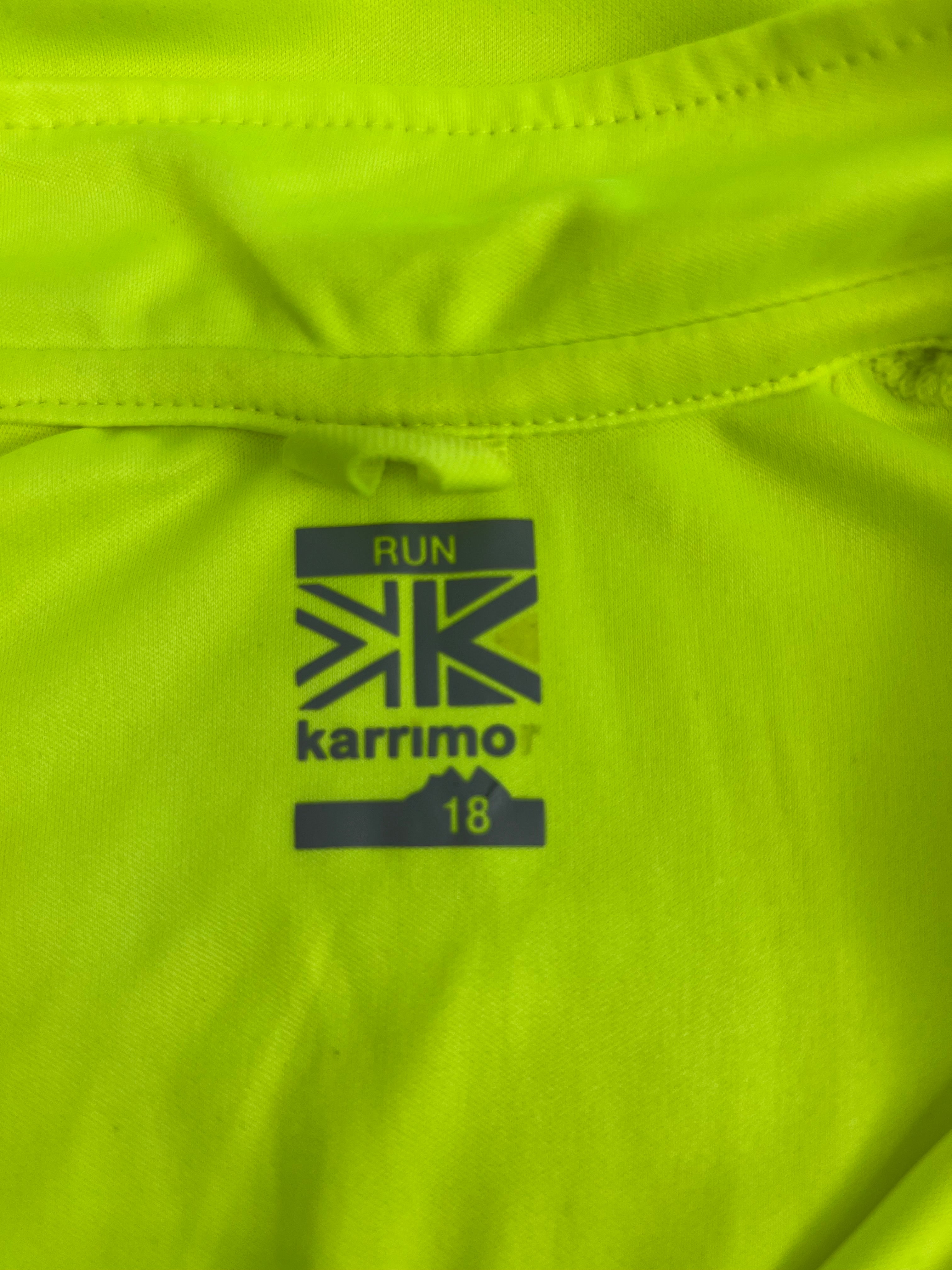 Close-up of Karrimor logo and run 18 printed on inside neck of green run top