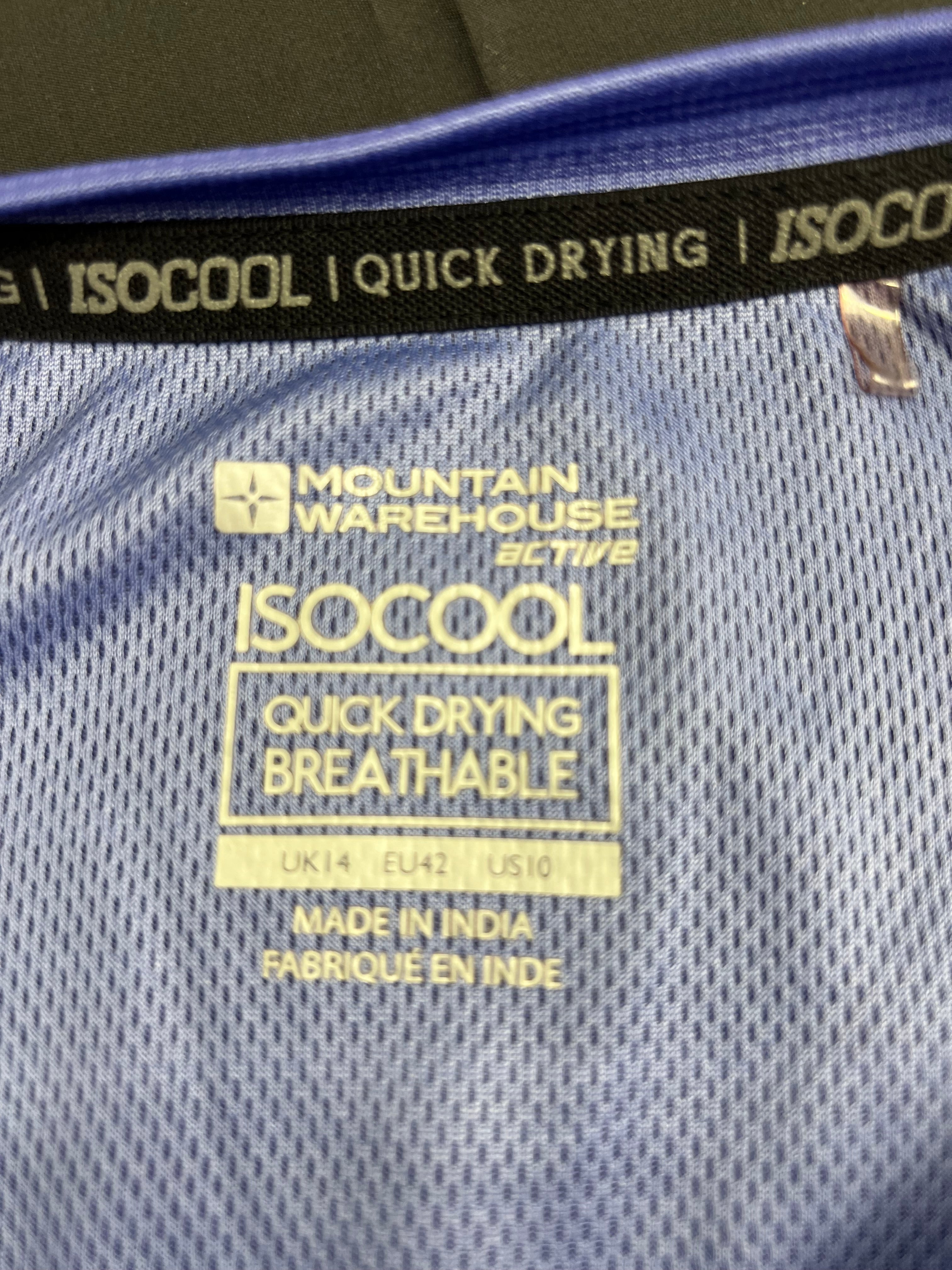 Close-up of Mountain Warehouse Isocool label highlighting quick drying and breathable fabric