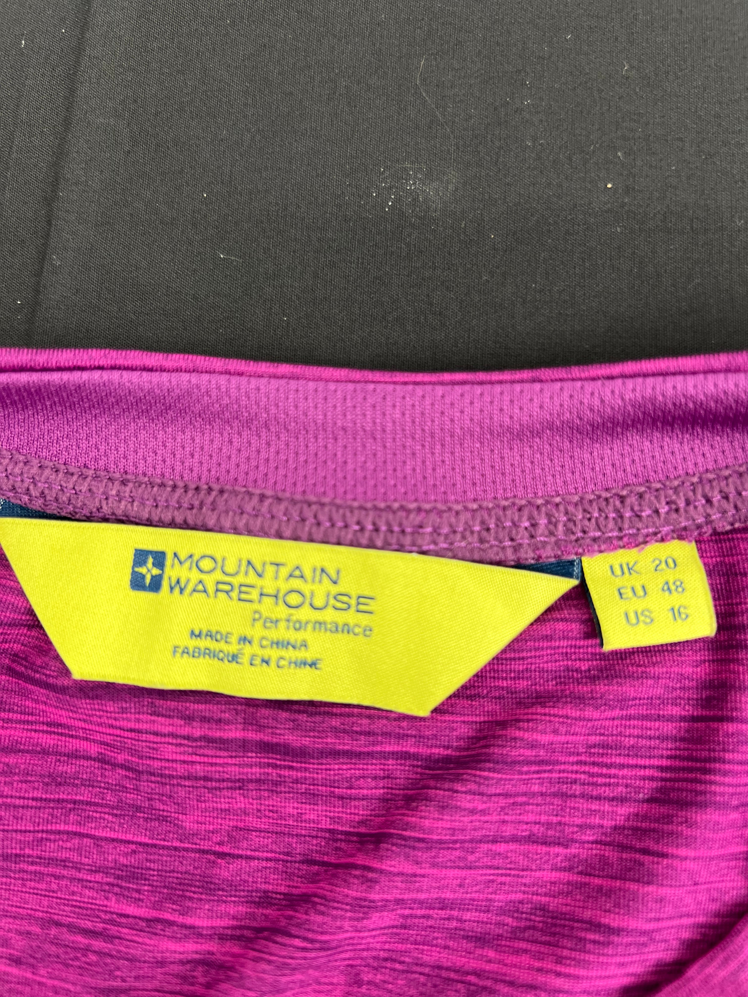 Close-up of Mountain Warehouse label and size tag inside purple T-shirt