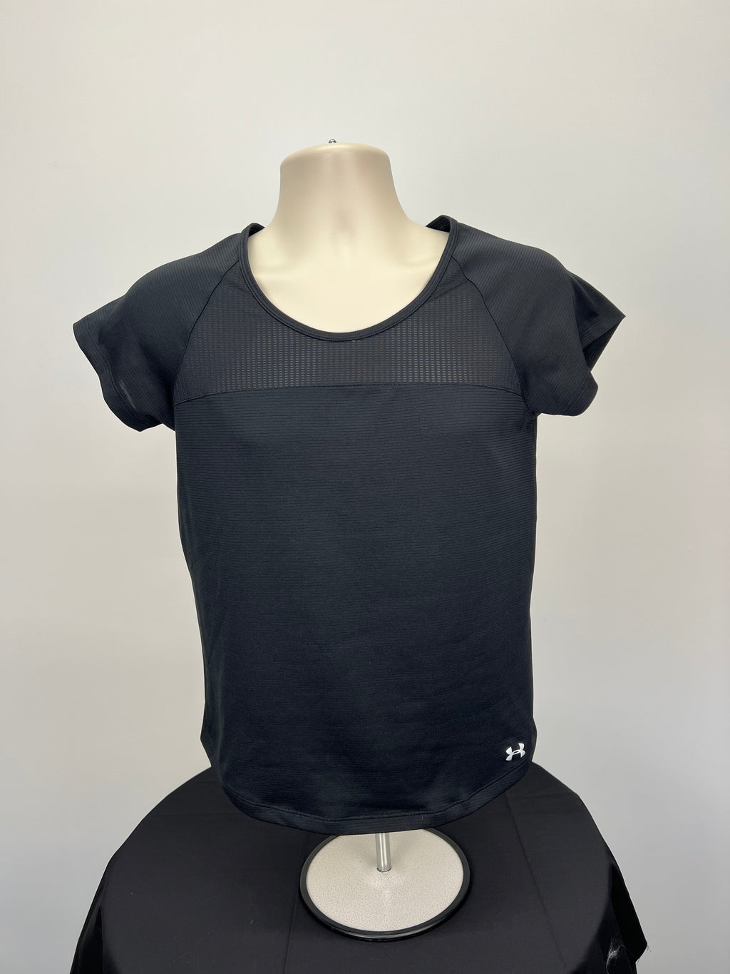 Front view of under armour women's black T-shirt with mesh upper chest panel