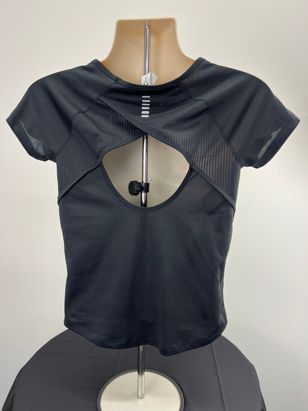 Back view of under armour women's black T-shirt showing cut-out and cross-over back design