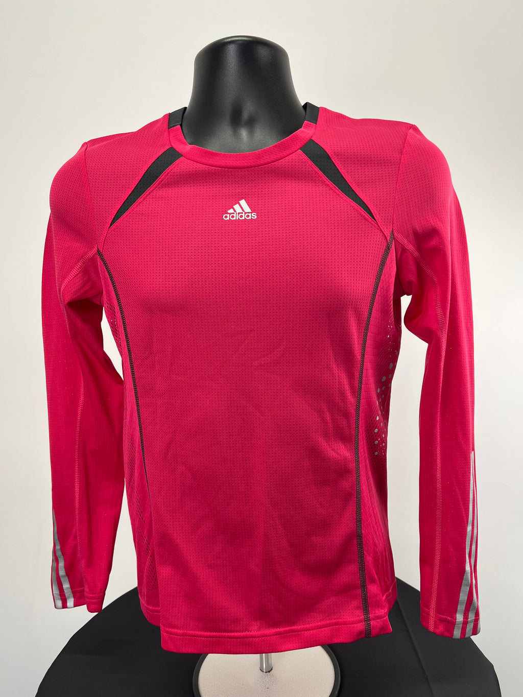 Front view of Adidas long sleeve base layer top in bright pink with black accents and white Adidas logo