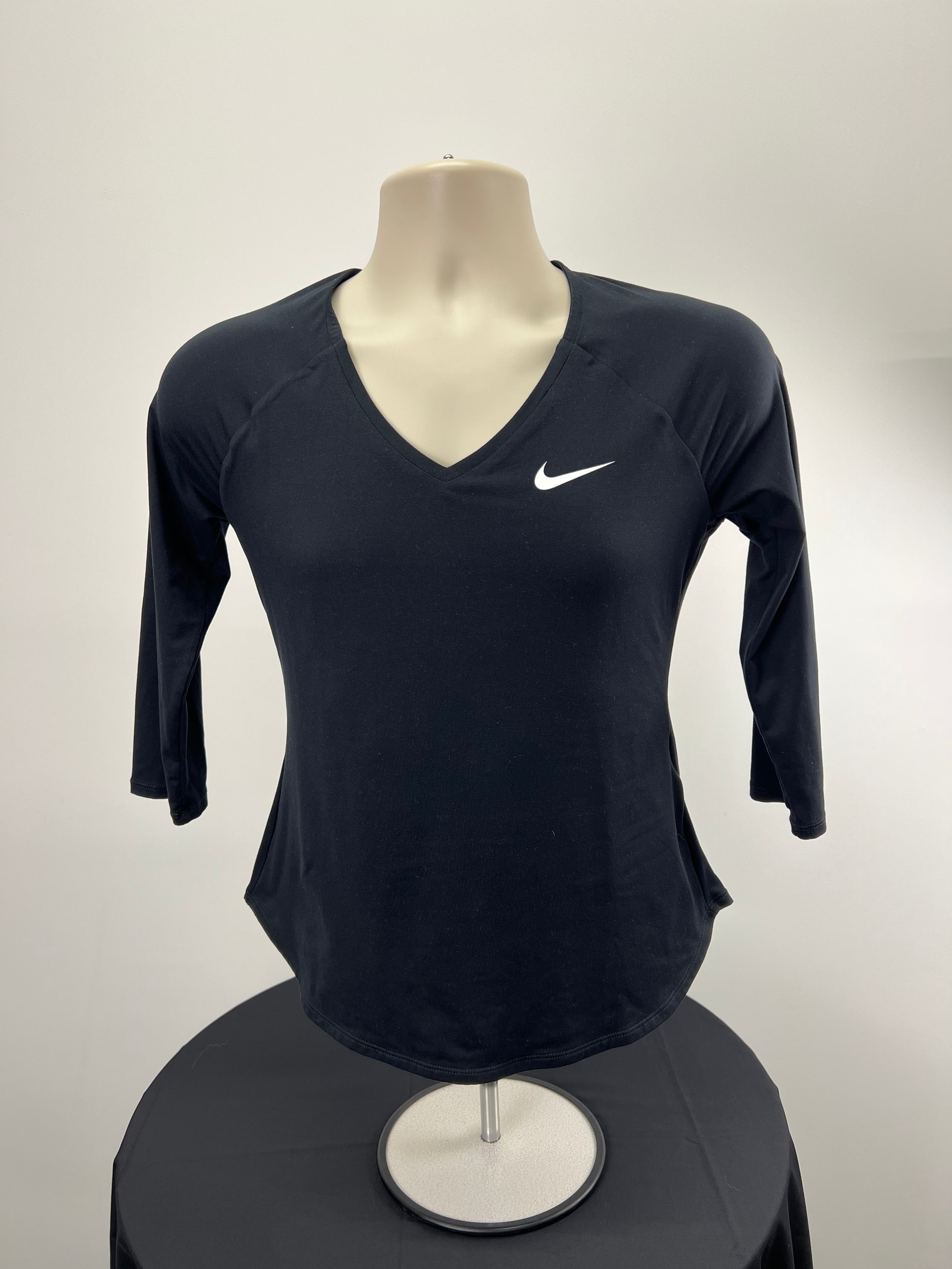 Front view of women’s Nike black V-neck long sleeve top on display mannequin