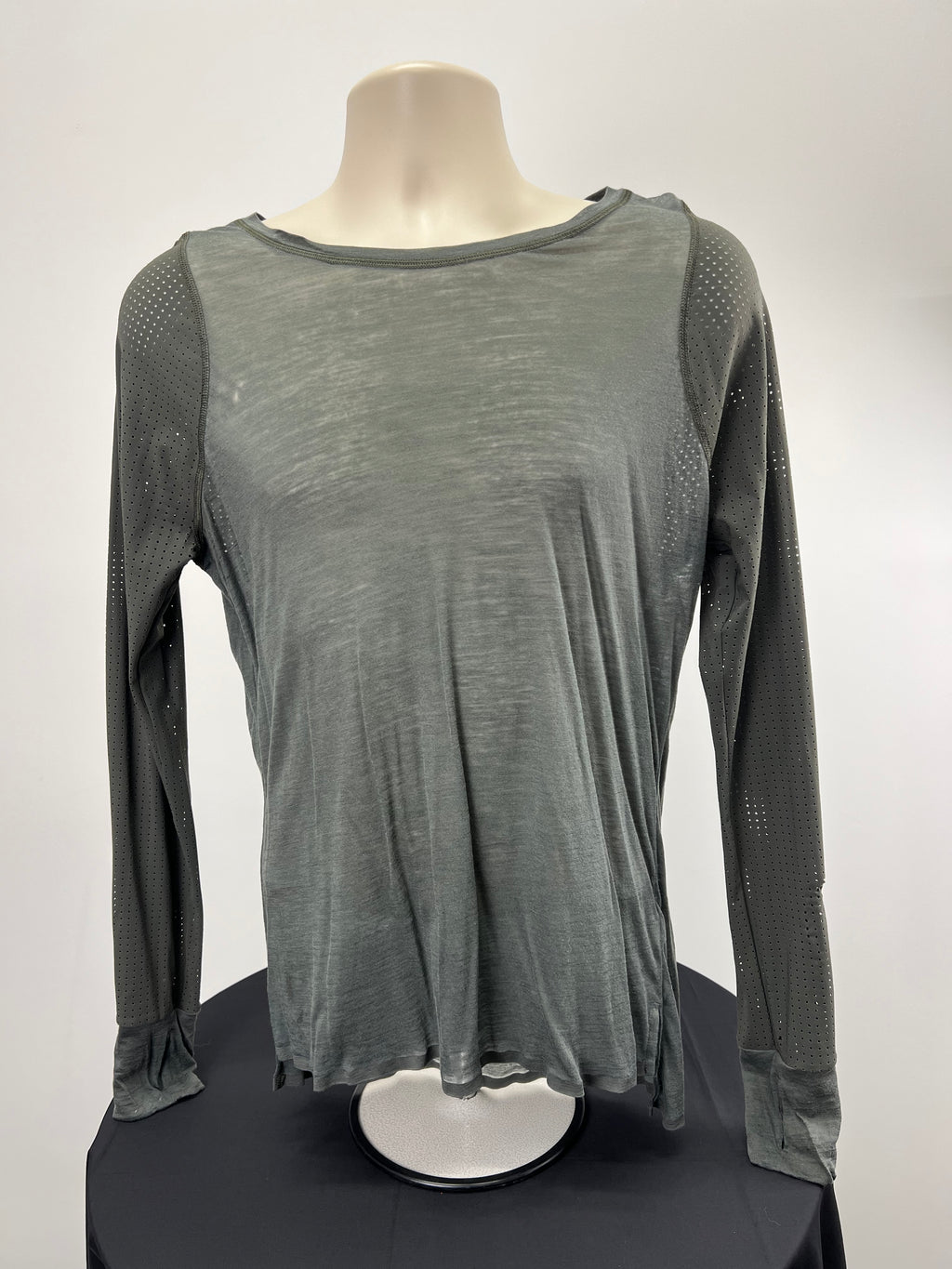 Front view of Sweaty Betty grey long sleeved athletic top size medium on display stand