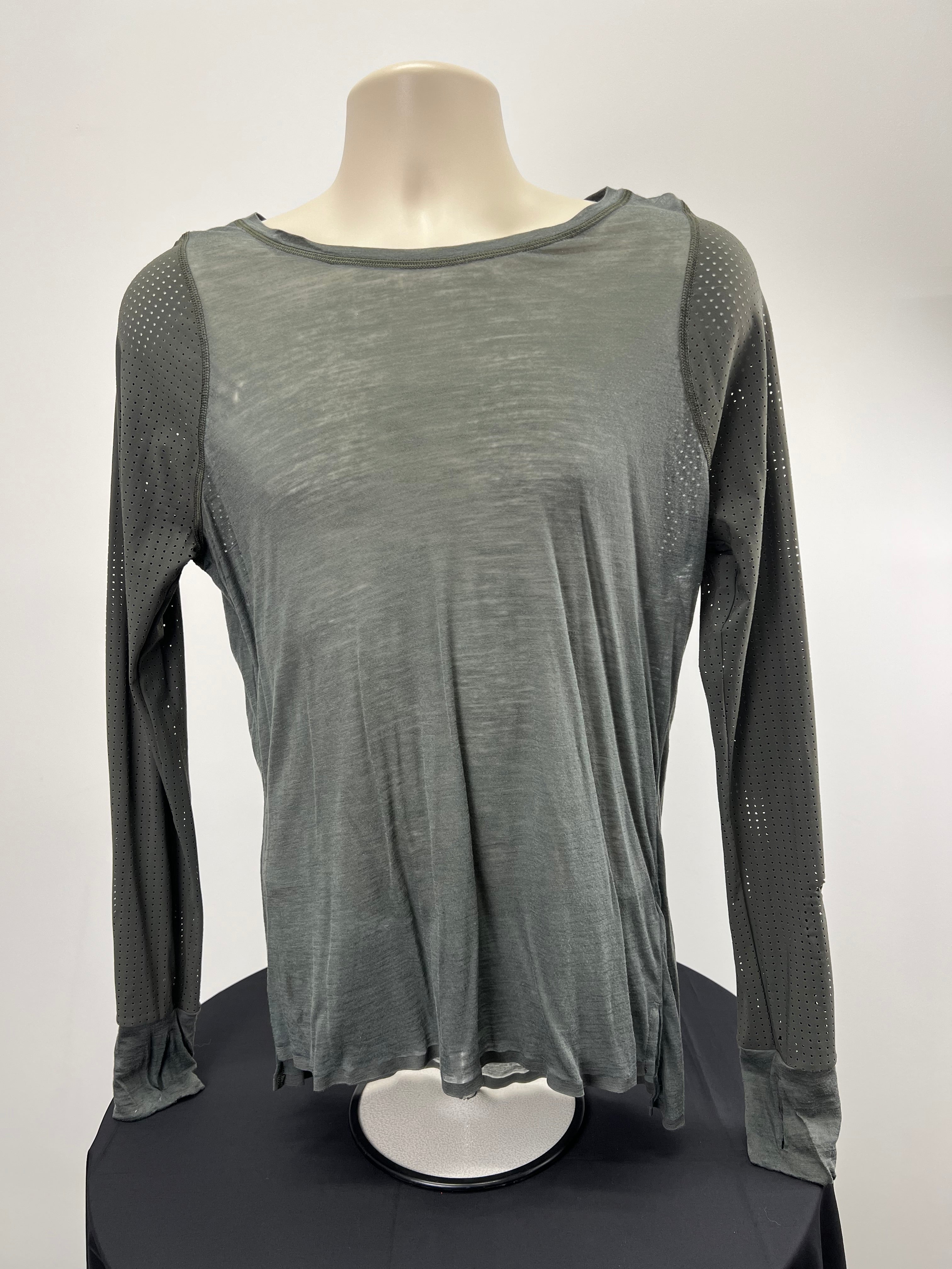 Front view of Sweaty Betty grey long sleeved athletic top size medium on display stand