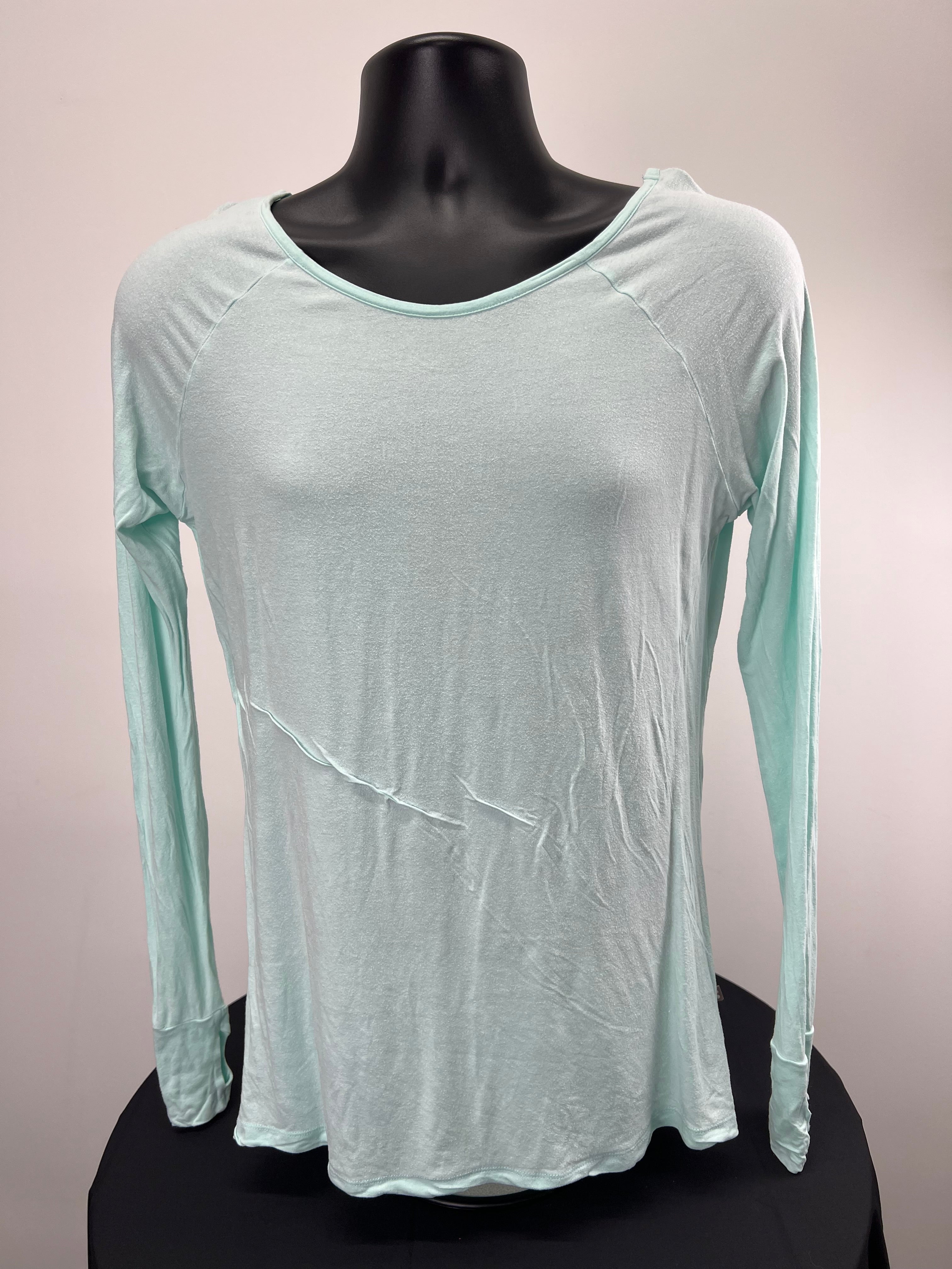 Front view of light green Sweaty Betty long sleeve top on mannequin