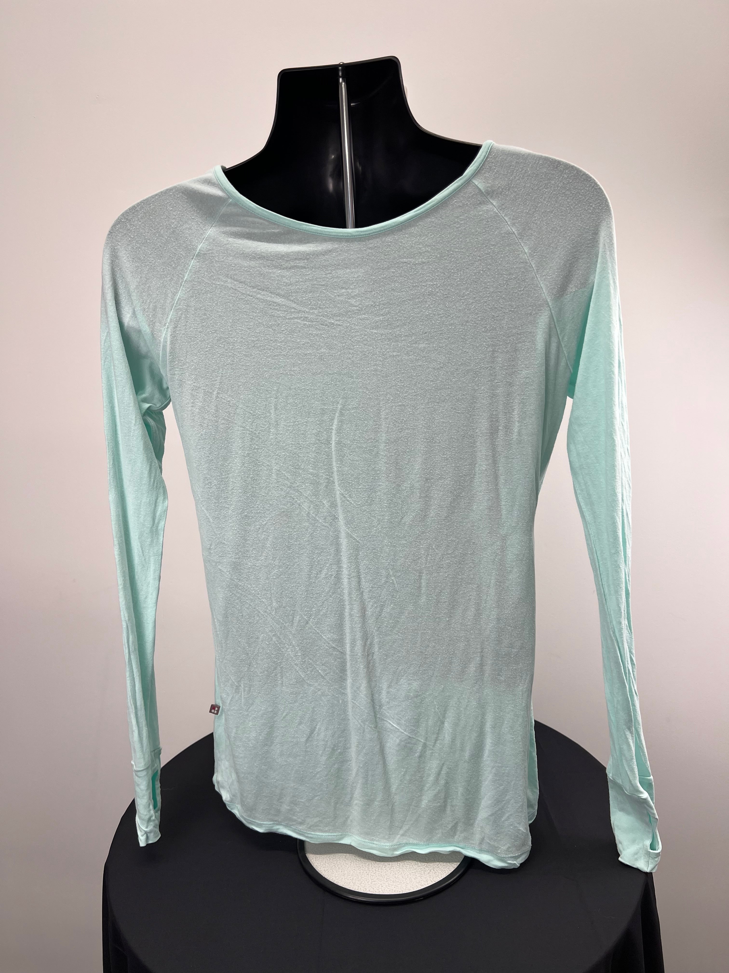 Back view of light green Sweaty Betty long sleeve top showing relaxed fit