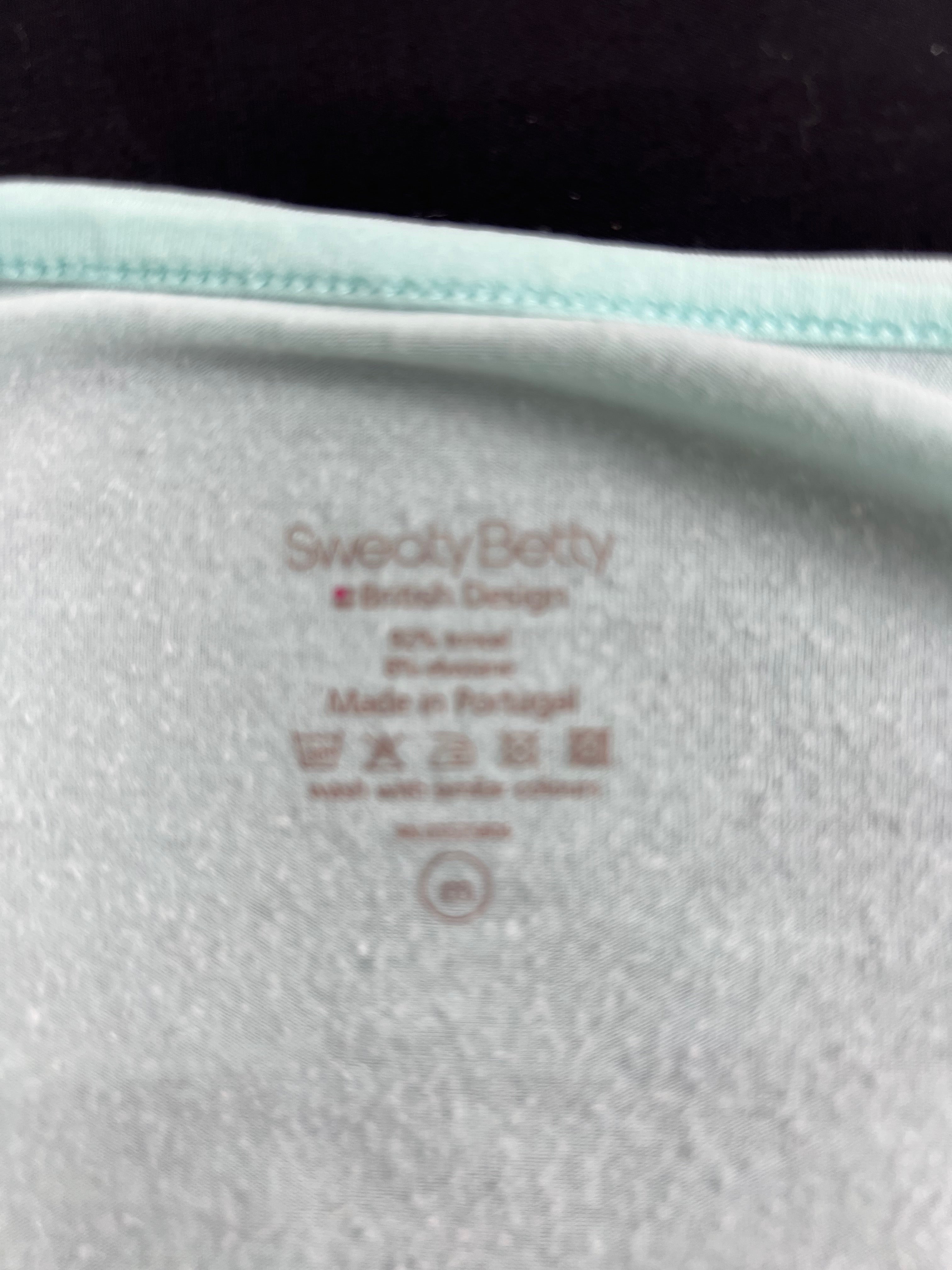 Close-up of inner label of Sweaty Betty top showing material and care instructions