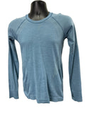 Front view of light blue Sweaty Betty long sleeve seamless active top on black mannequin