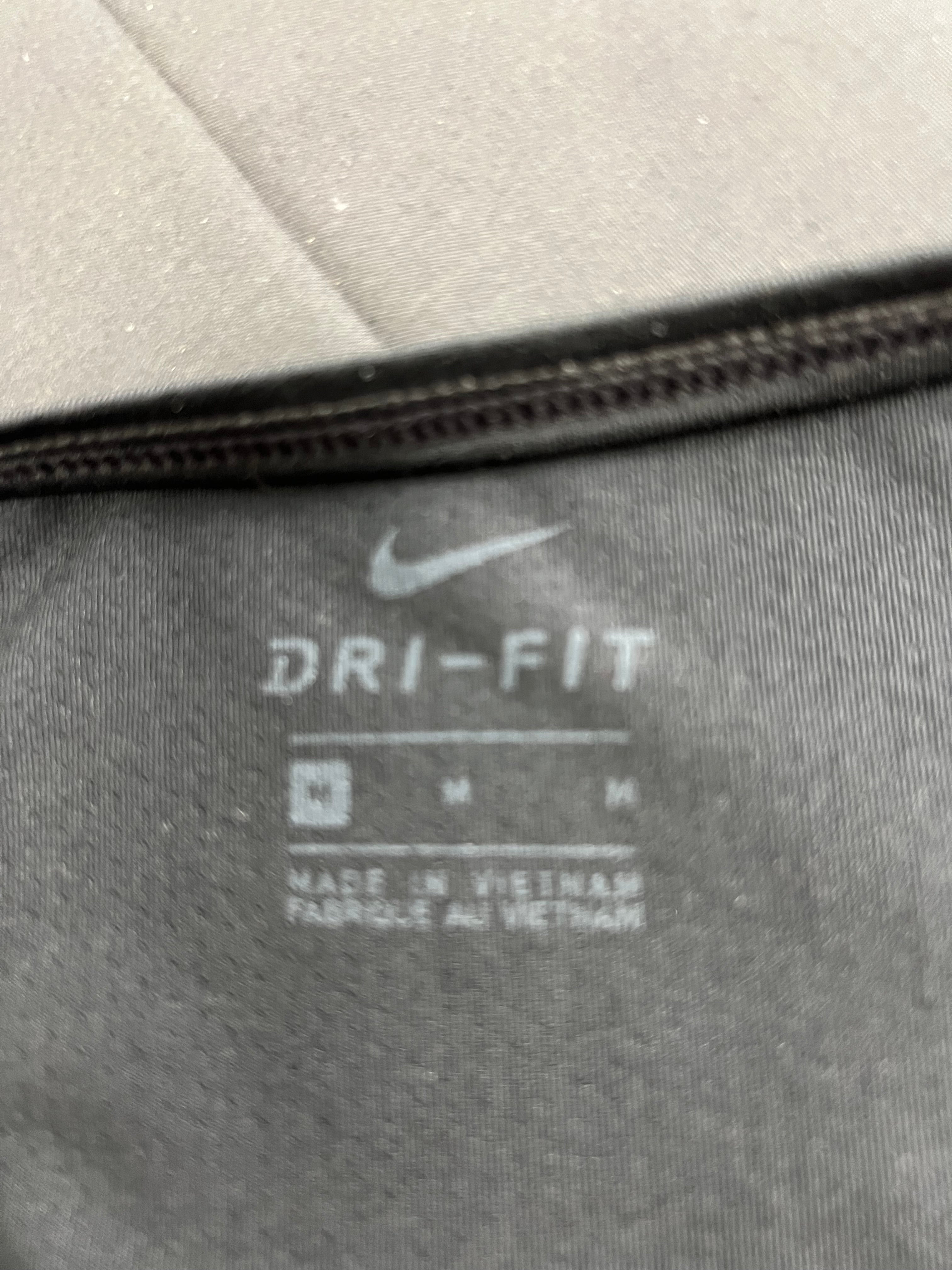 Close-up of inside label showing Nike Dri-Fit logo and medium size
