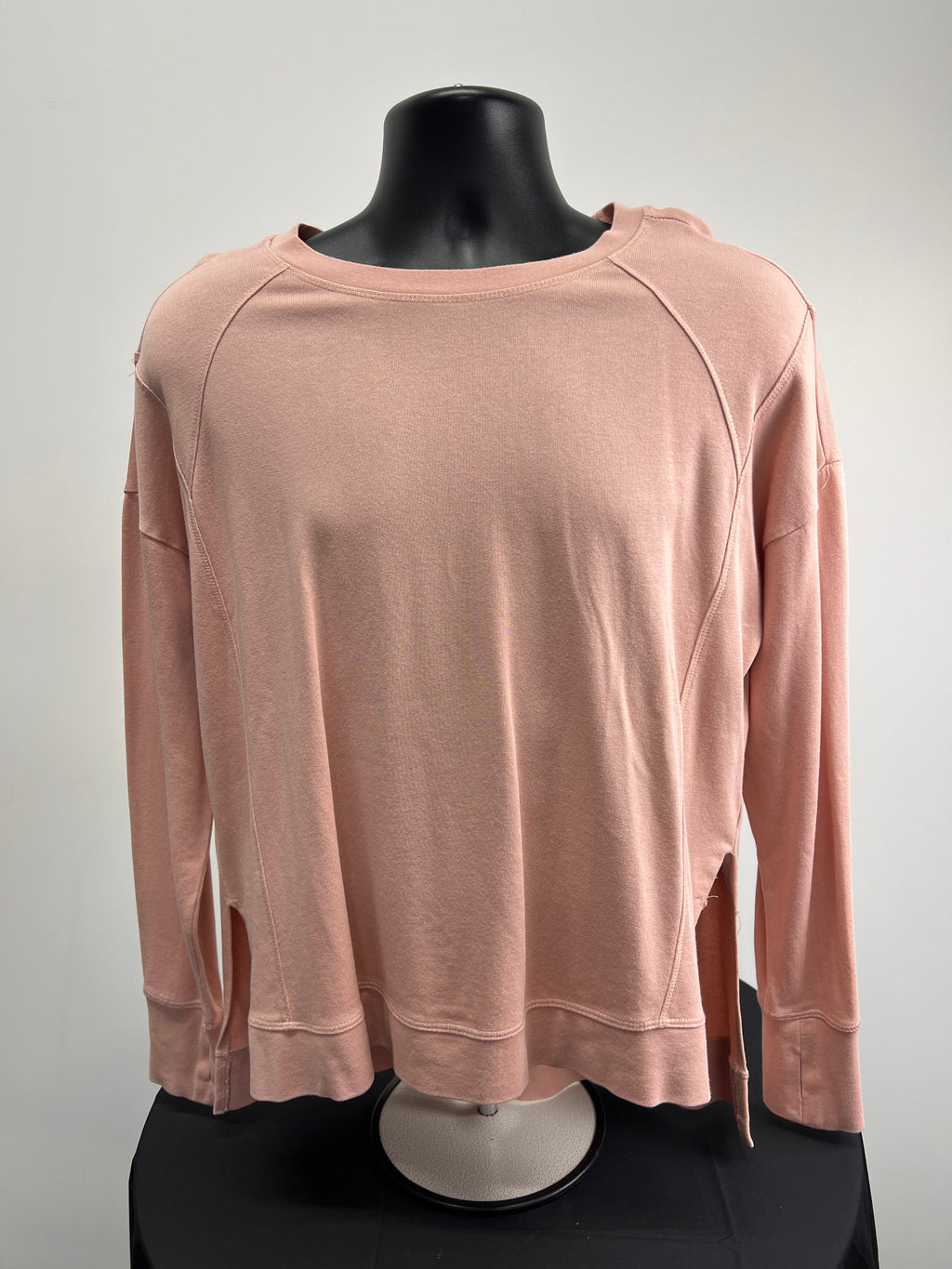 Front view of Sweaty Betty light pink long sleeve sweatshirt on black mannequin