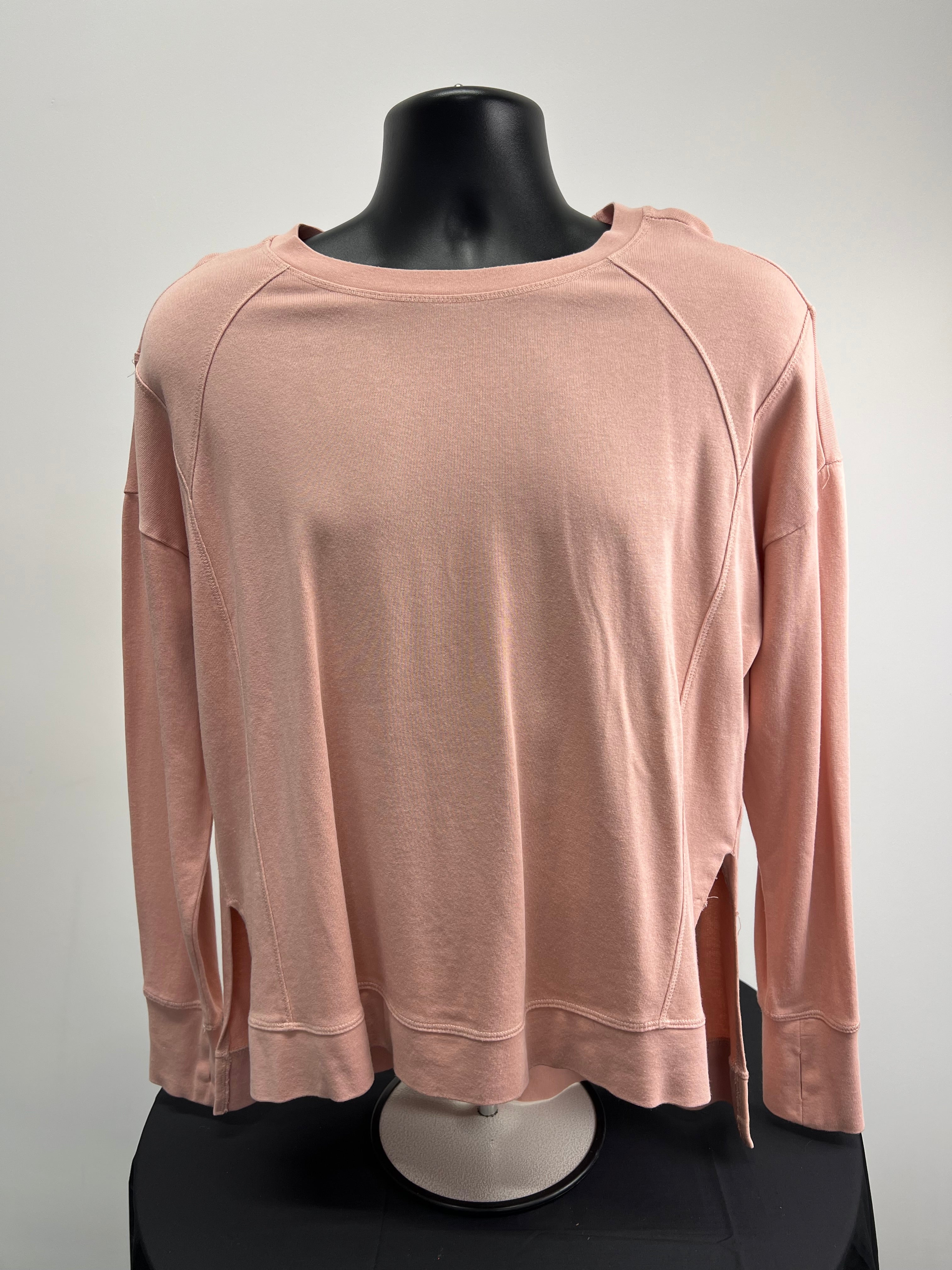 Front view of Sweaty Betty light pink long sleeve sweatshirt on black mannequin