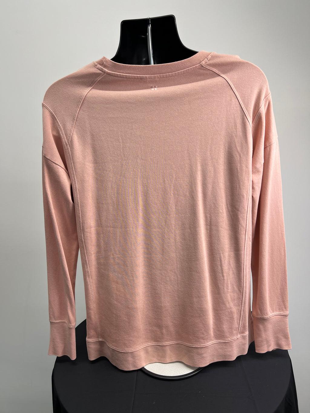 Back view of Sweaty Betty light pink long sleeve sweatshirt on black mannequin