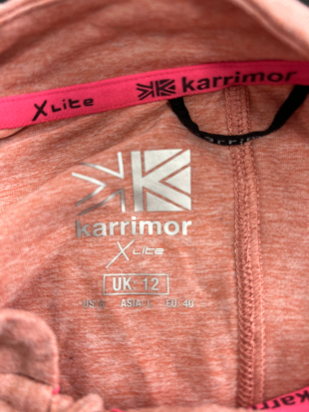 Close-up of Karrimor X Lite size label inside light pink long sleeve top showing UK size 12