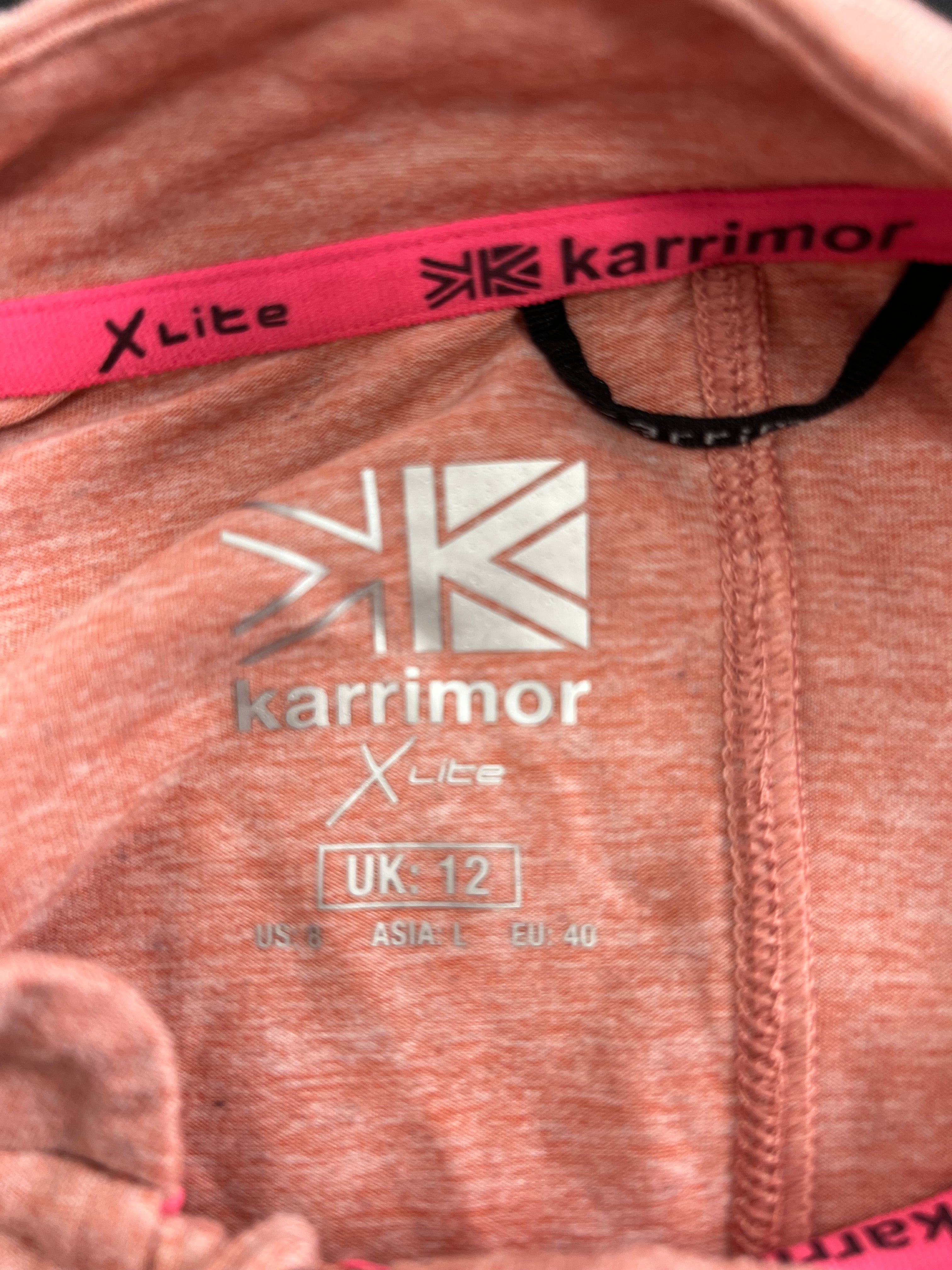 Close-up of Karrimor X Lite size label inside light pink long sleeve top showing UK size 12