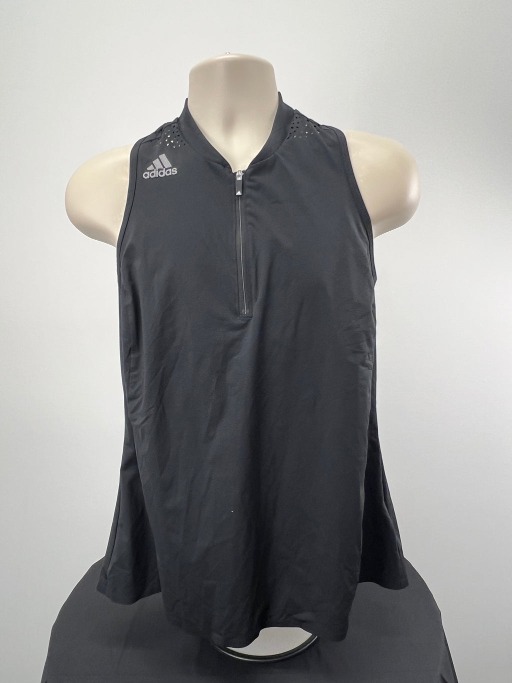 Front view of Adidas black sleeveless 1/2 zip top with bra support on mannequin