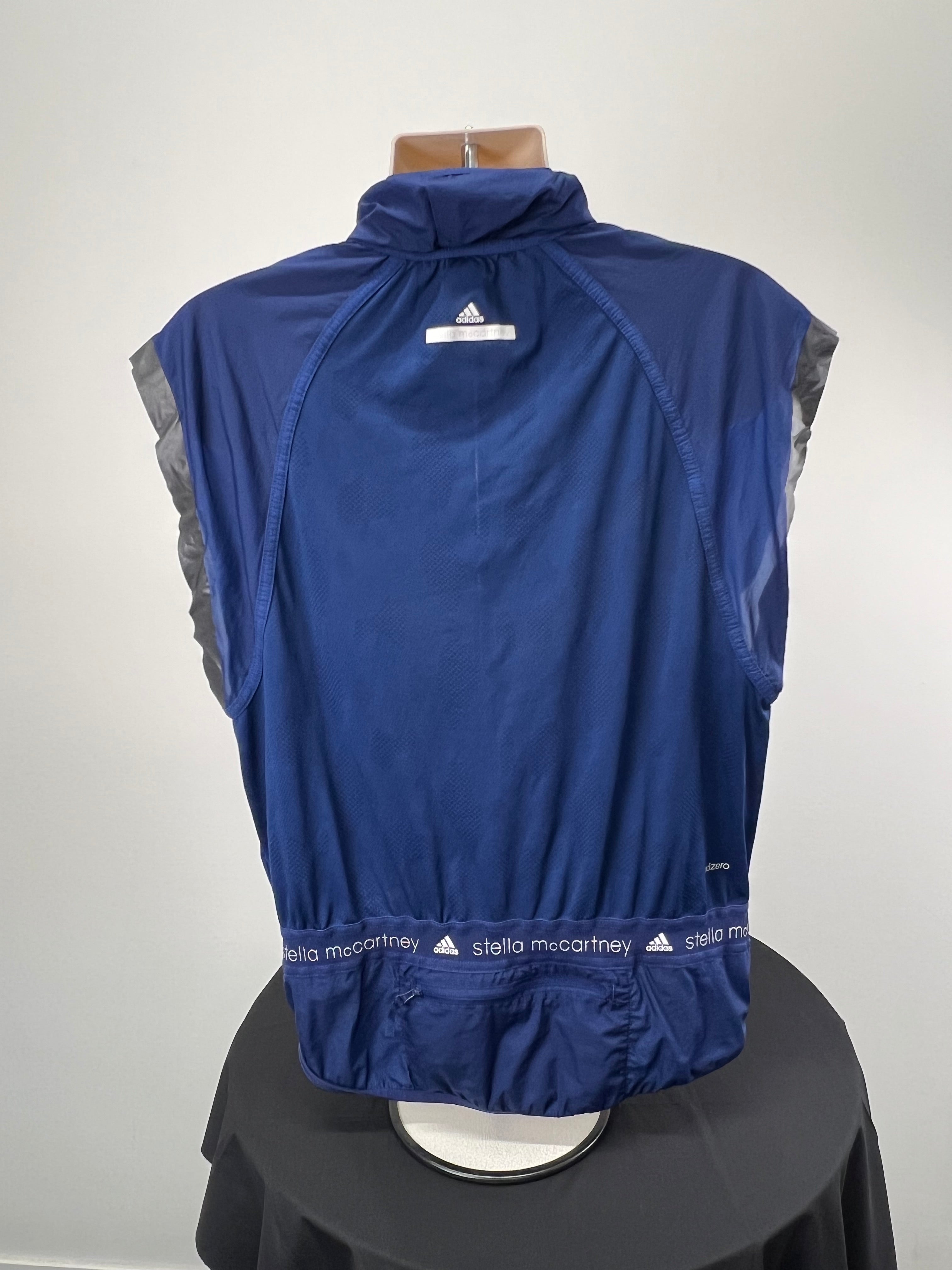 Back view of Adidas x Stella McCartney navy blue sleeveless full zip running top showing reflective logo and mesh fabric