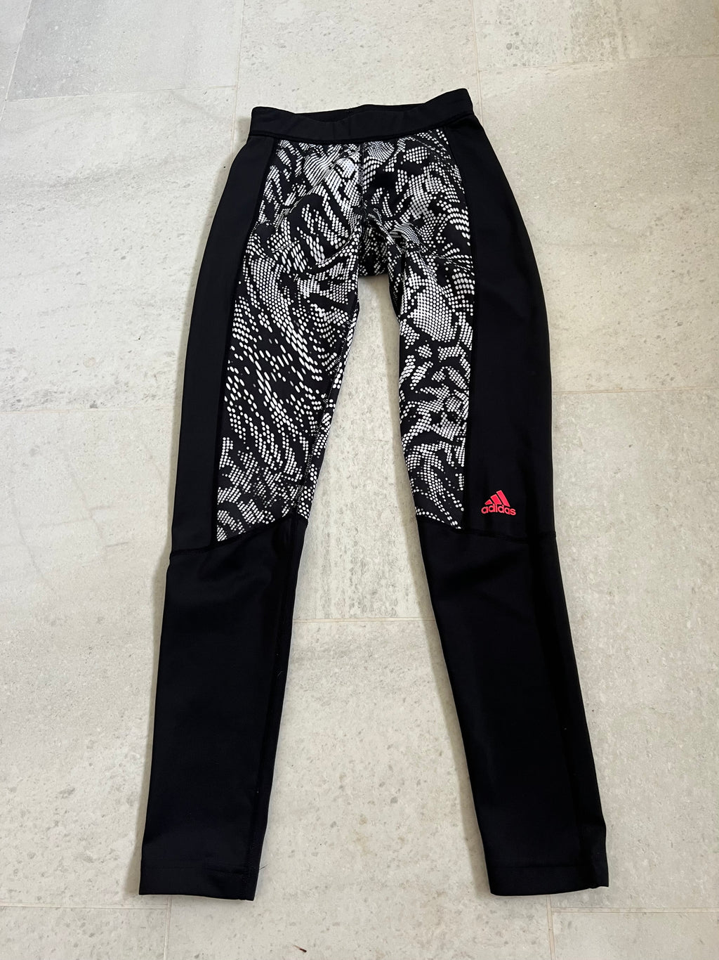 adidas Techfit leggings in size XS laid flat showing front black and white patterned panels with black sides and red adidas logo