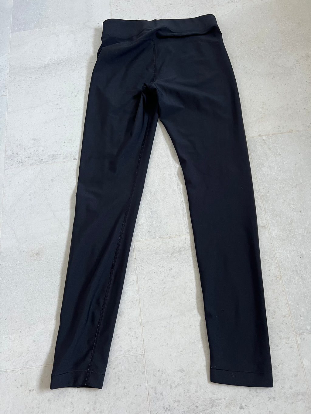 Back view of Under Armour black compression leggings showing sleek design