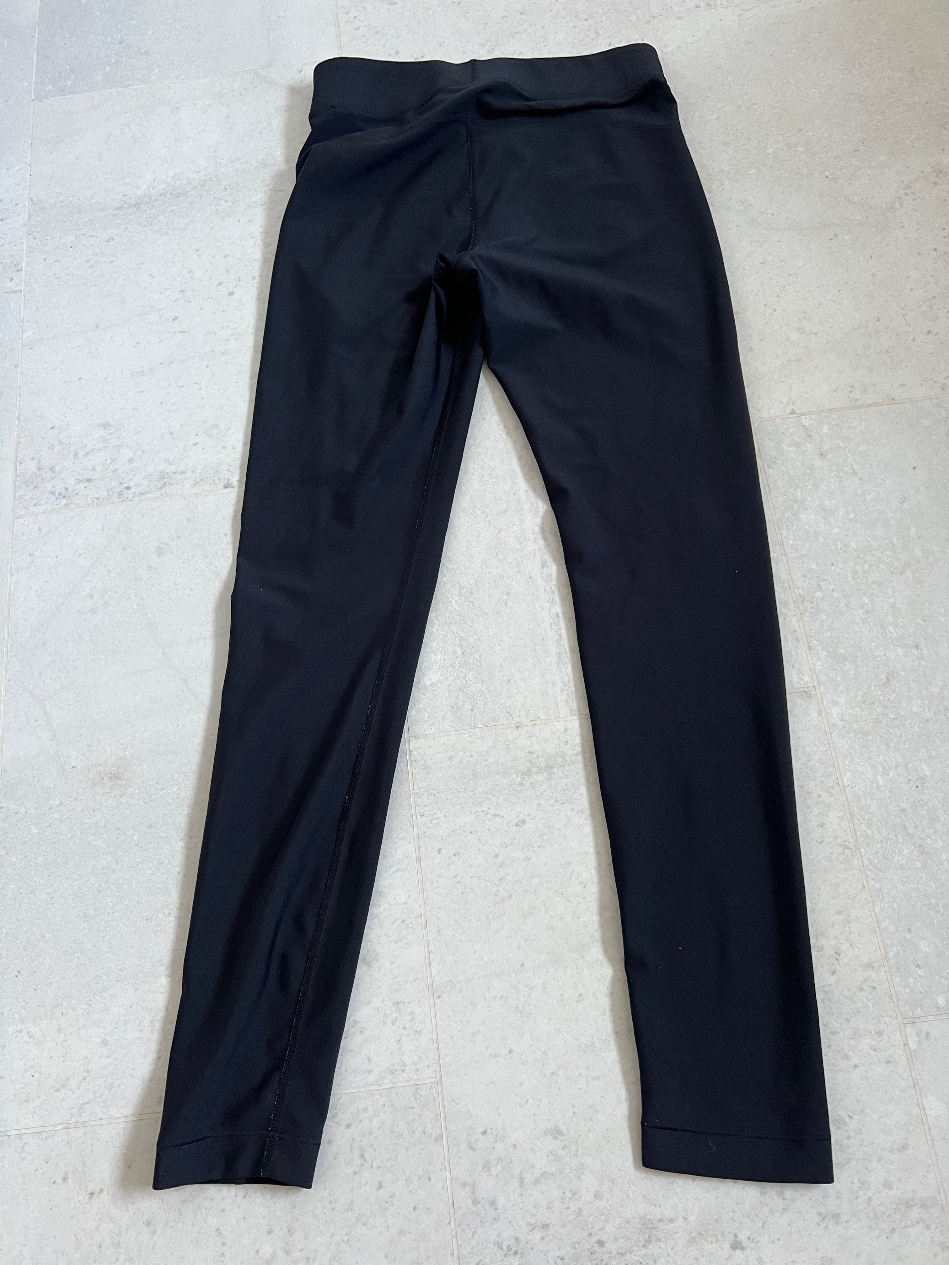 Back view of Under Armour black compression leggings showing sleek design