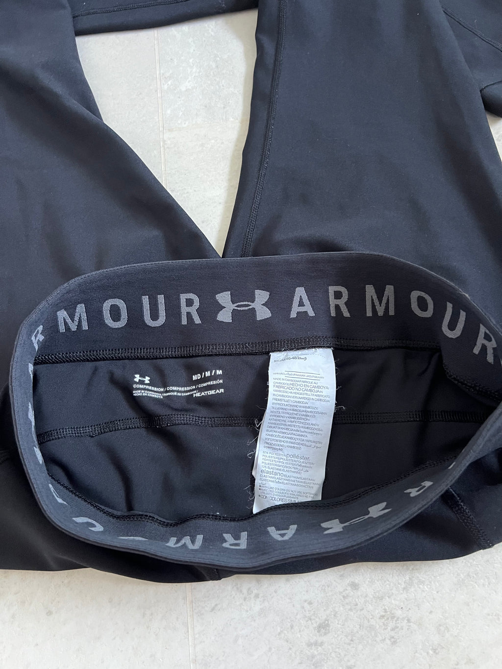 Close-up of Inside waistband showing Under Armour HeatGear branding and size tag