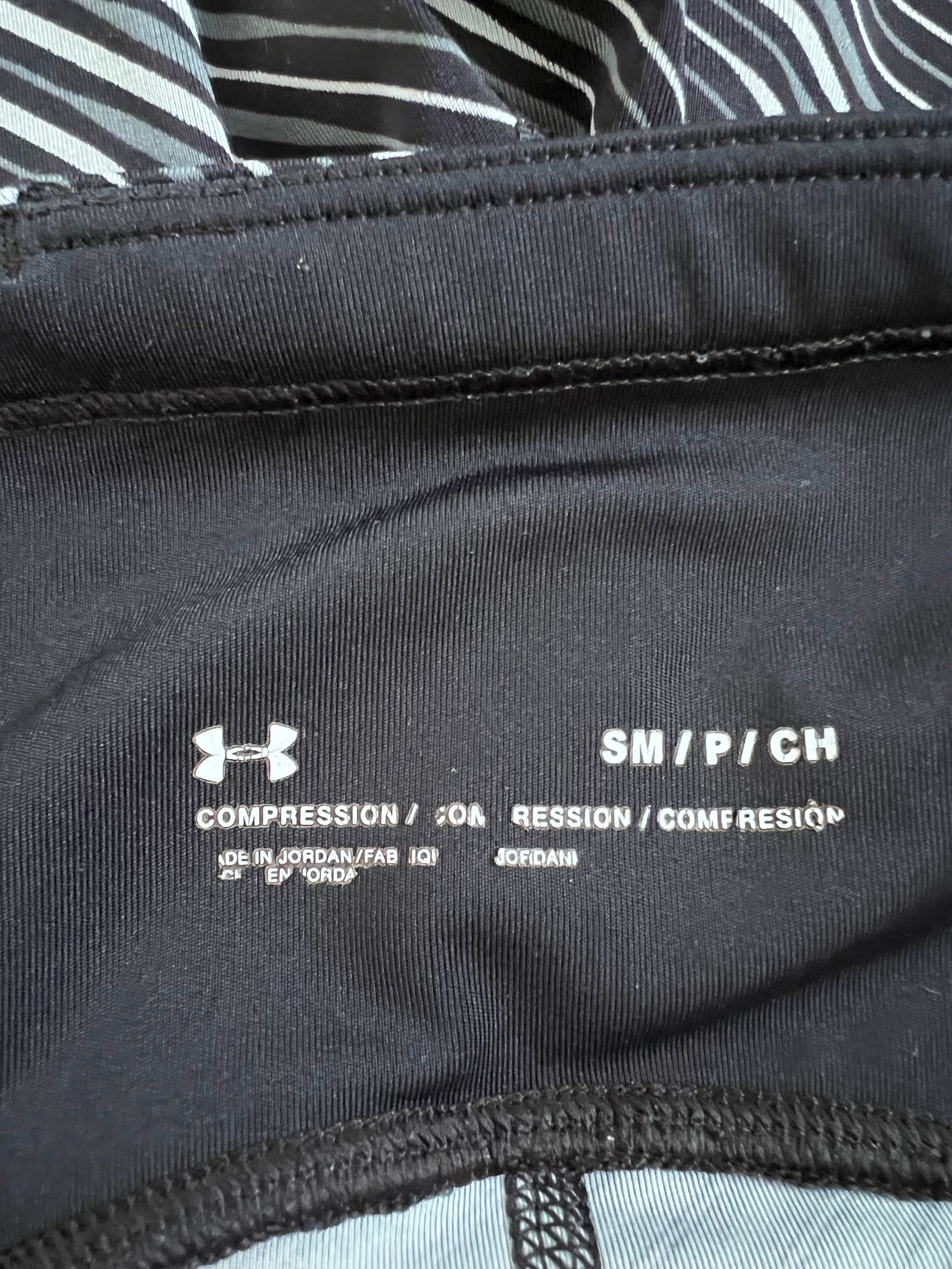 Close-up of inner waistband showing Under Armour logo and size label SM/P/CH