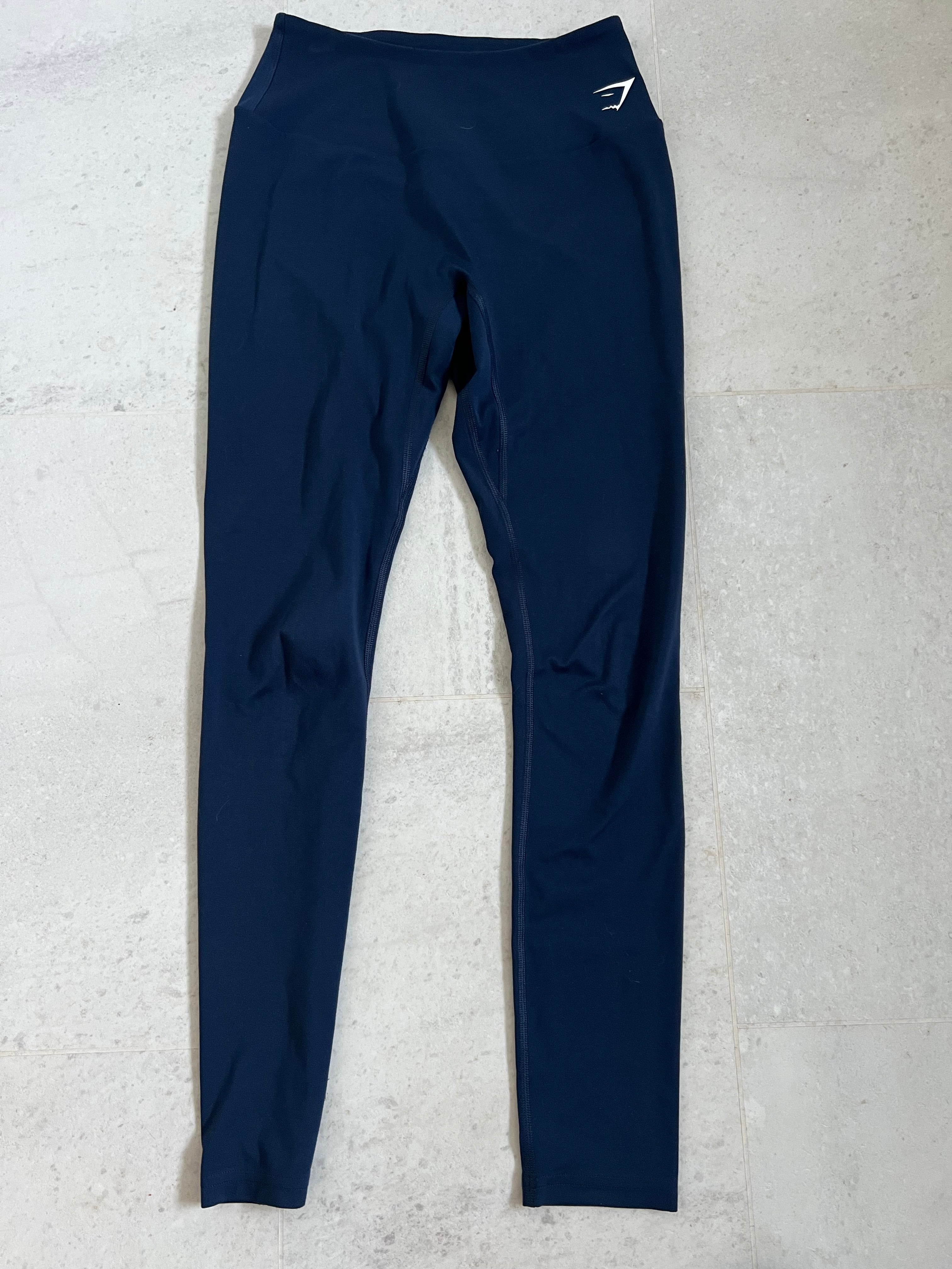 Front view of Gymshark full length blue leggings laid flat