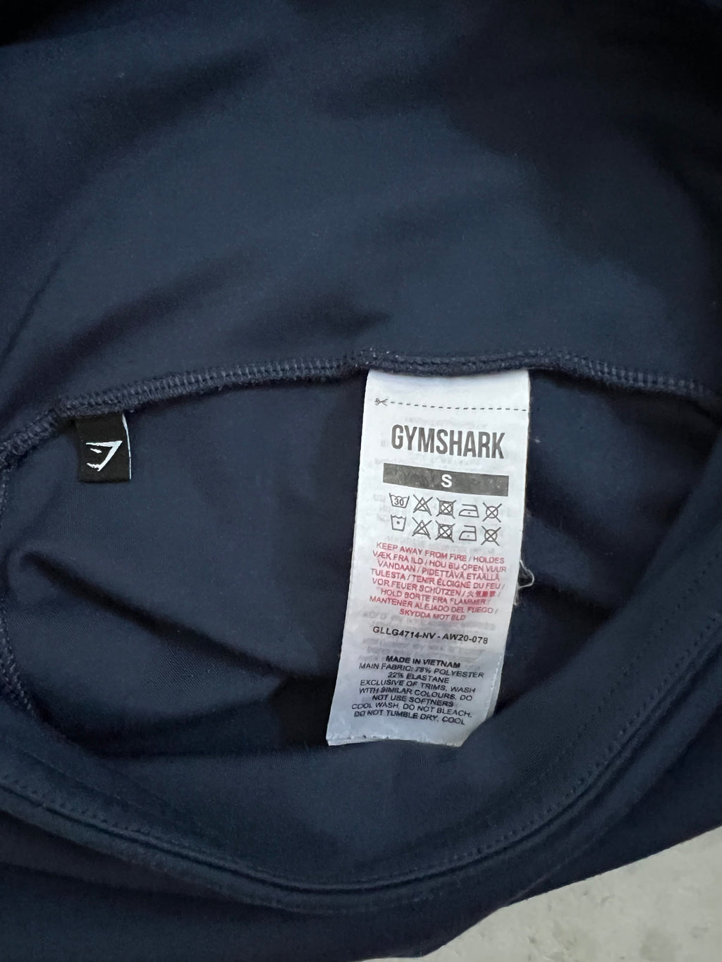 Close-up of Gymshark leggings care label showing material composition and size S