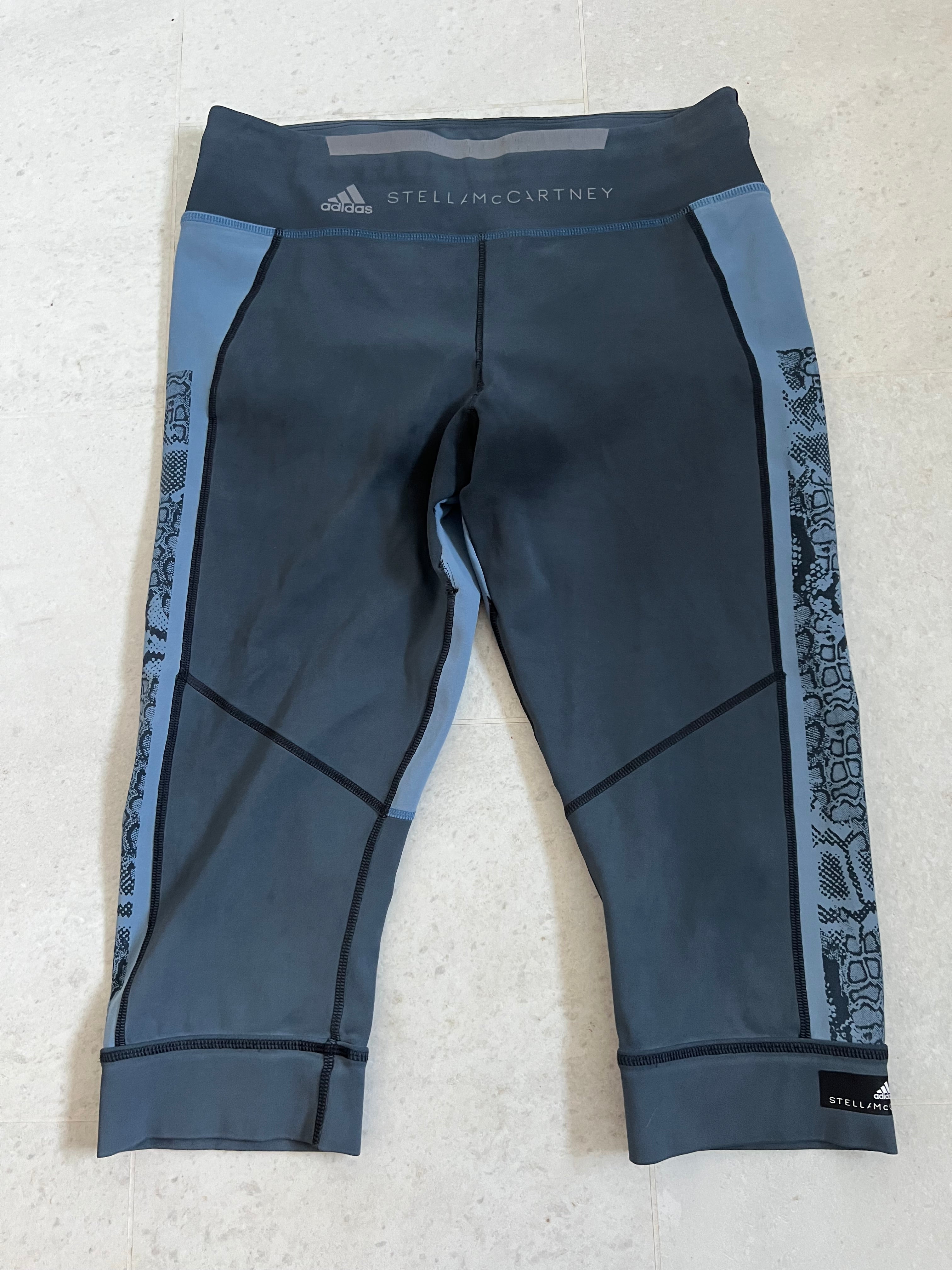 Front view of Adidas x Stella McCartney blue cropped leggings with snakeskin side pattern and branded waistband