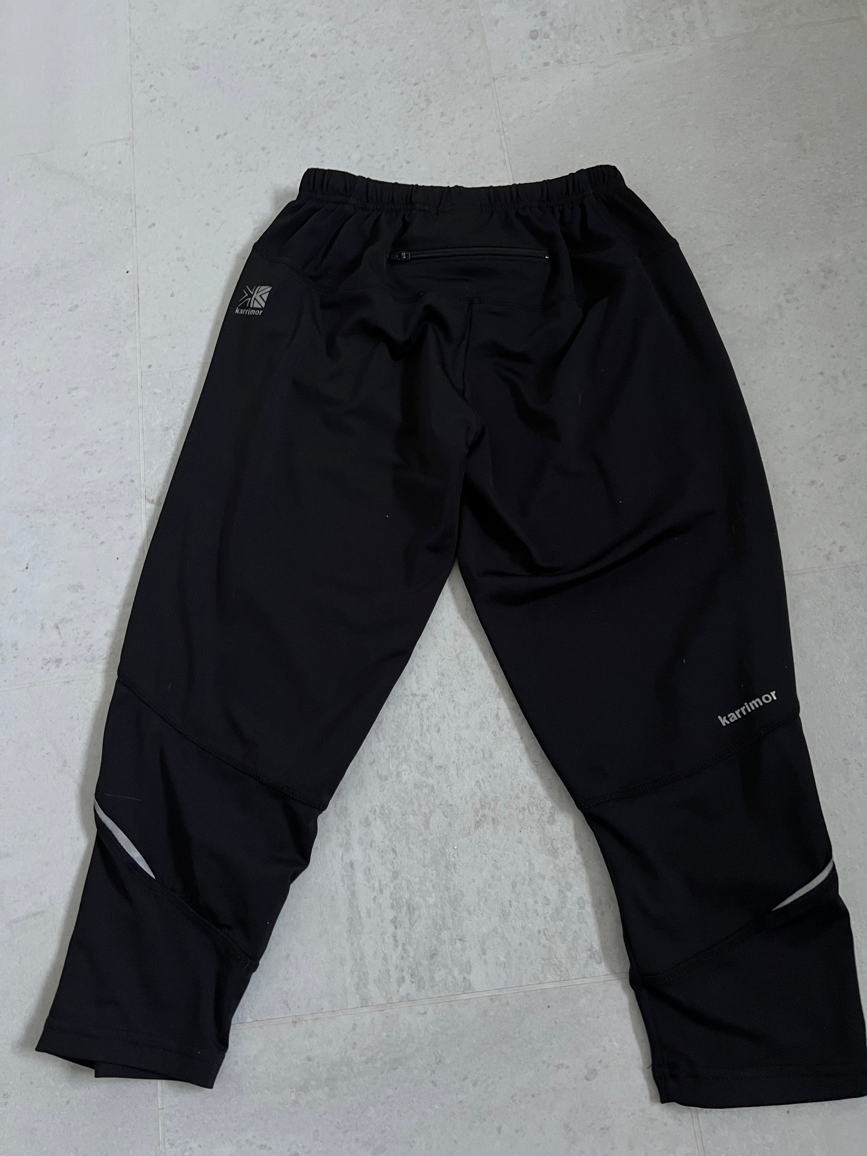 Back view of Karrimor black cropped leggings showing zip pocket and reflective details on lower legs
