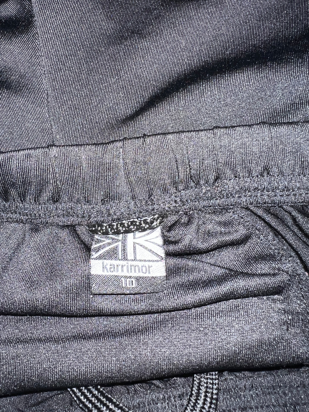 Close-up image of Karrimor tag inside leggings showing brand logo and size 10 label