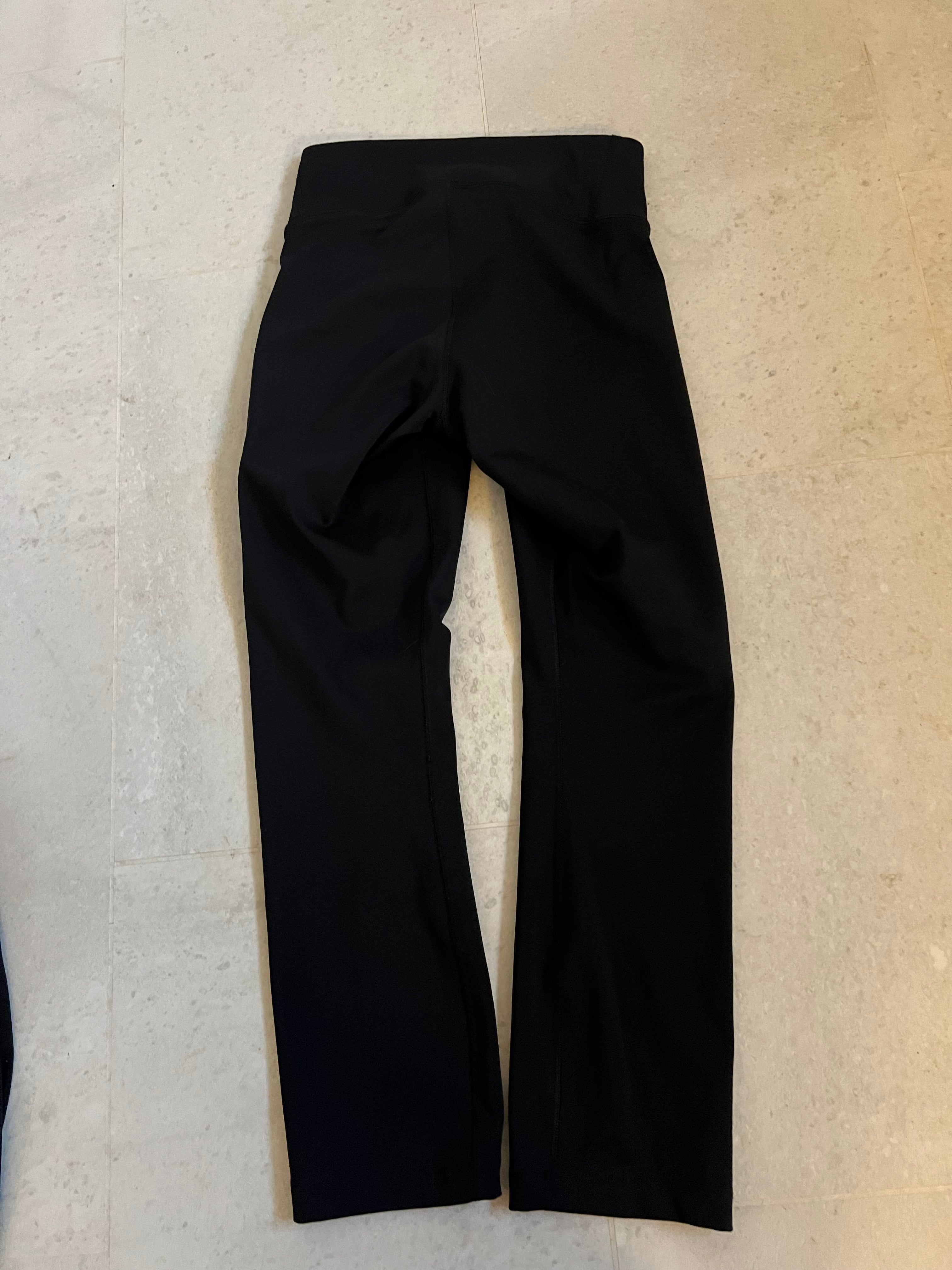 Back view of black Nike Dri-Fit cropped leggings showing smooth fabric and seam details