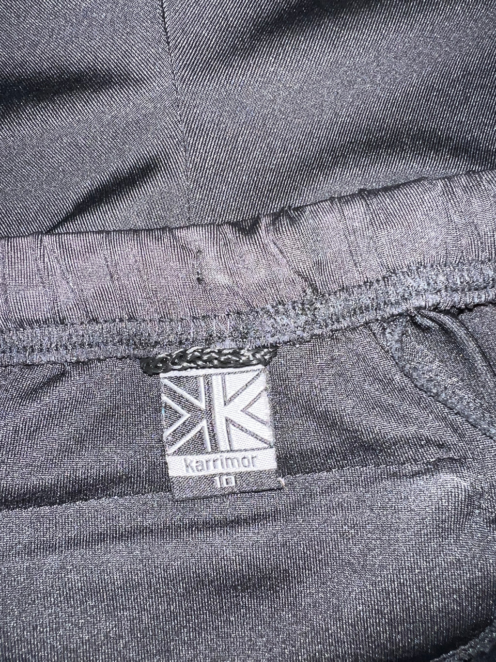 Close-up of Karrimor size 10 label stitched inside the black cropped leggings