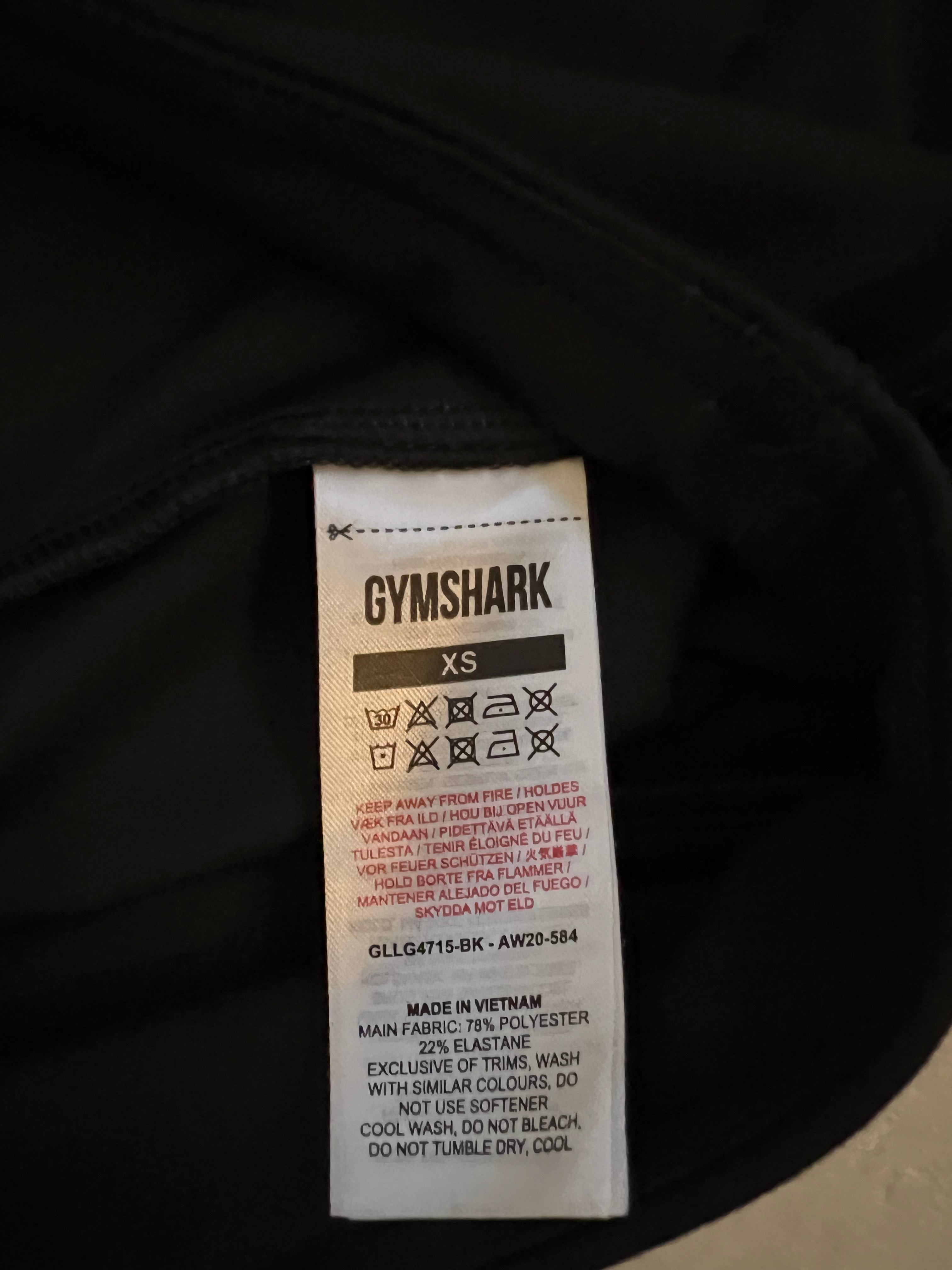 Close-up of the Gymshark leggings care label showing size XS and fabric composition
