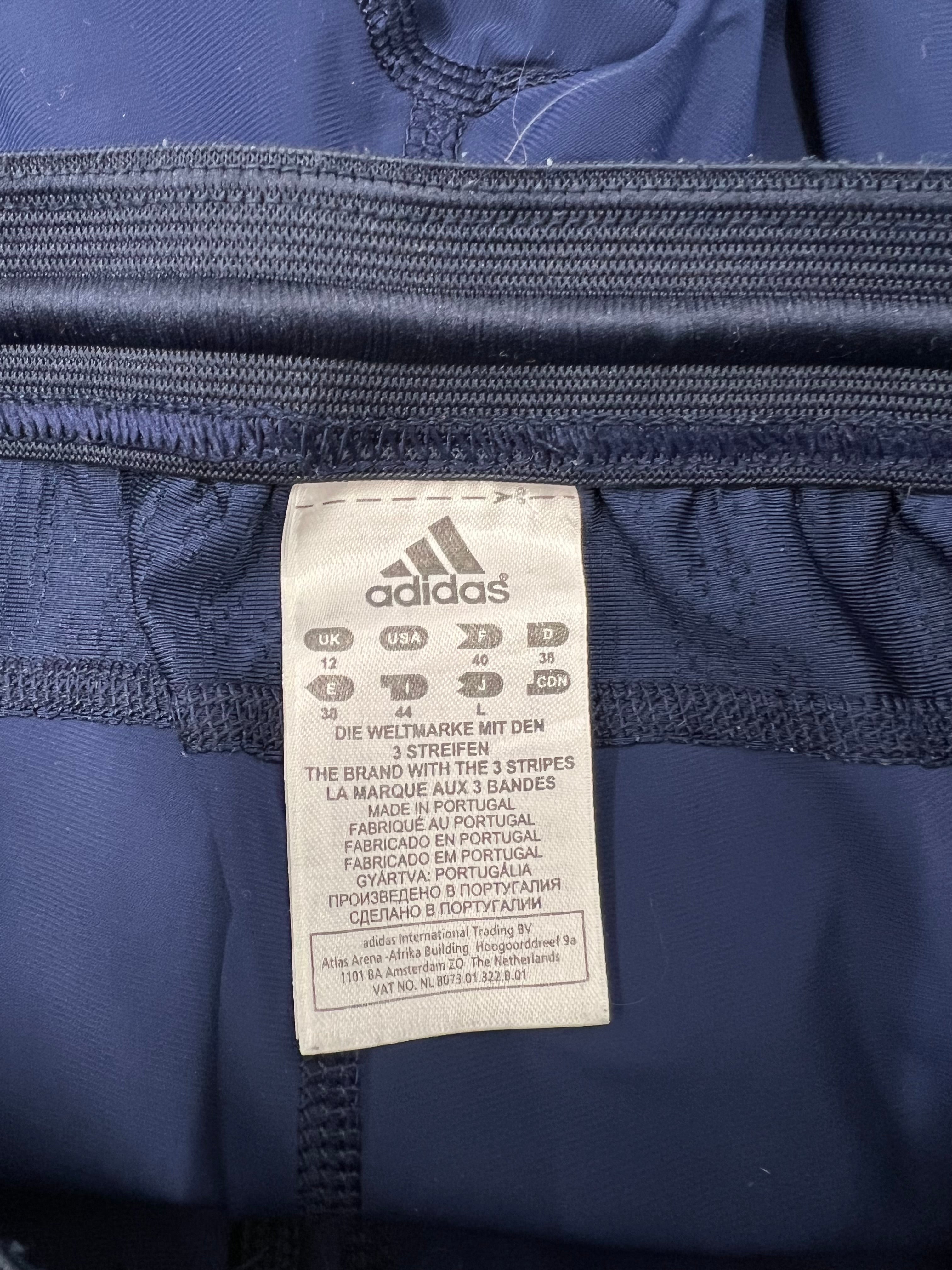 Close-up of Adidas size label inside navy blue leggings made in Portugal