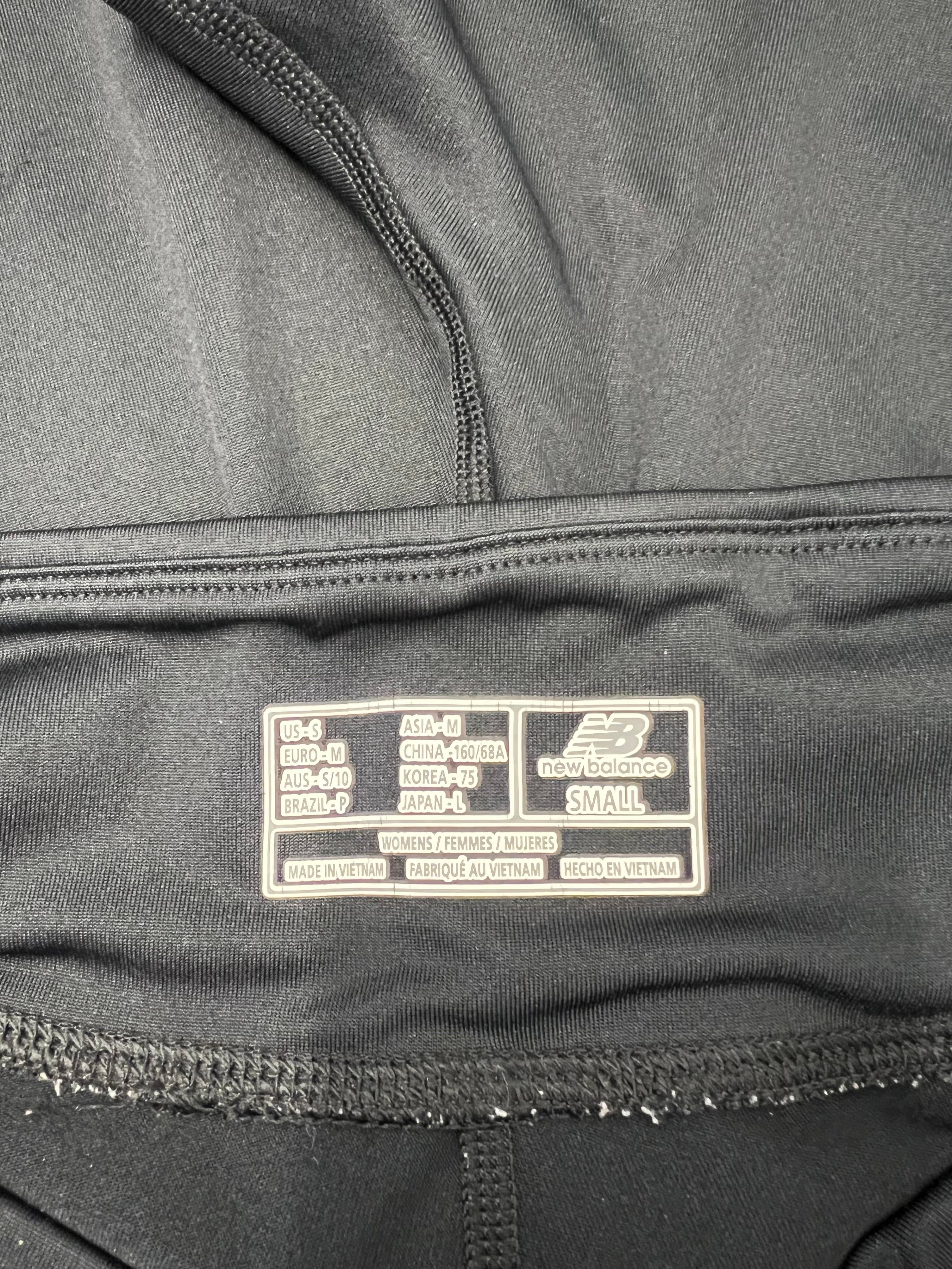 Inside label of New Balance Lightning Dry cropped leggings showing size and manufacturing details