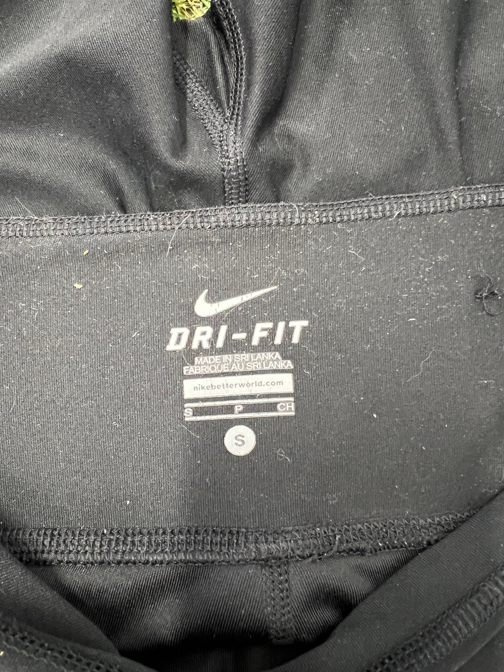 Close-up of Nike label inside the waistband showing Dri-FIT technology and size small