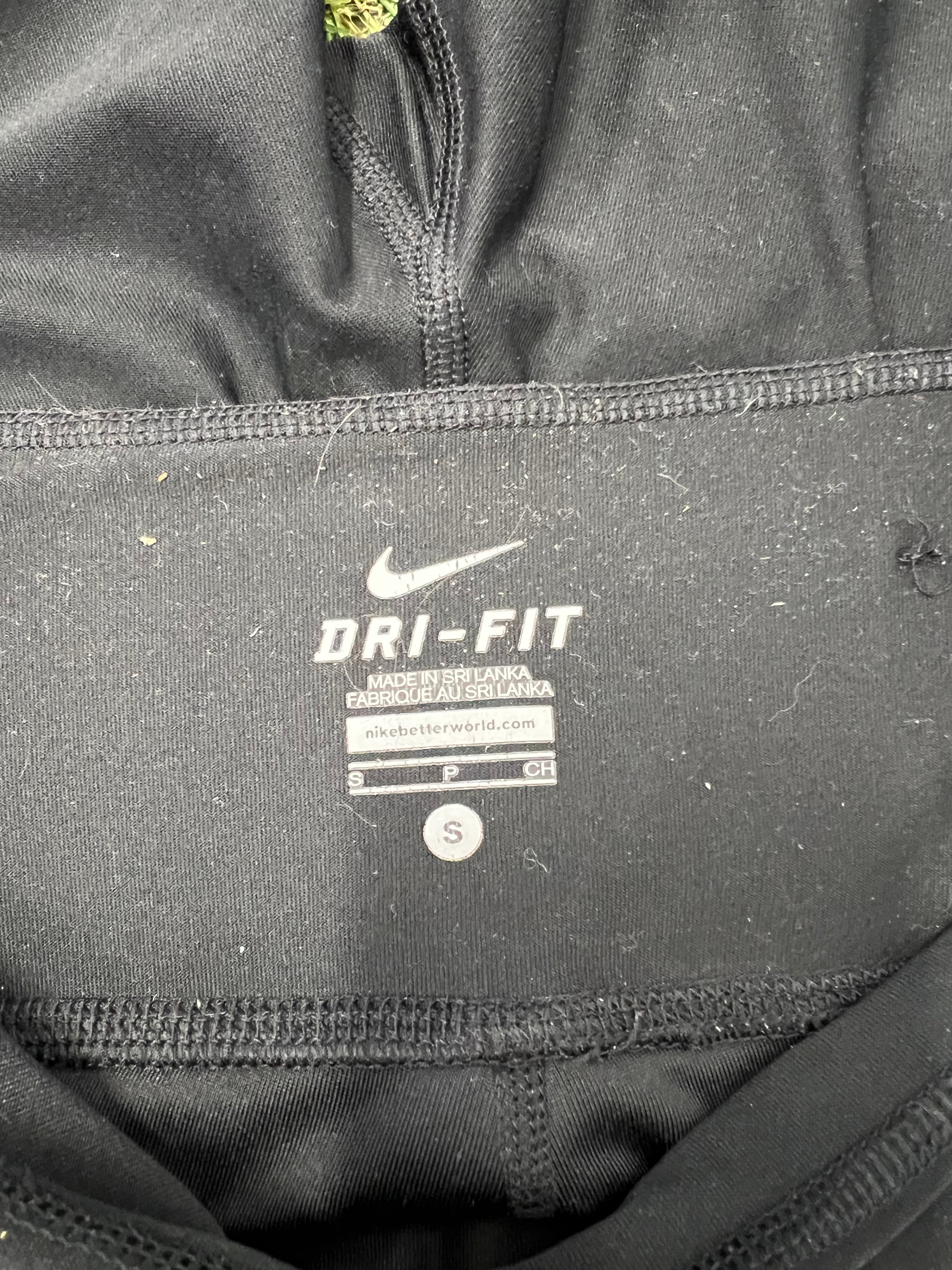 Close-up of Nike label inside the waistband showing Dri-FIT technology and size small