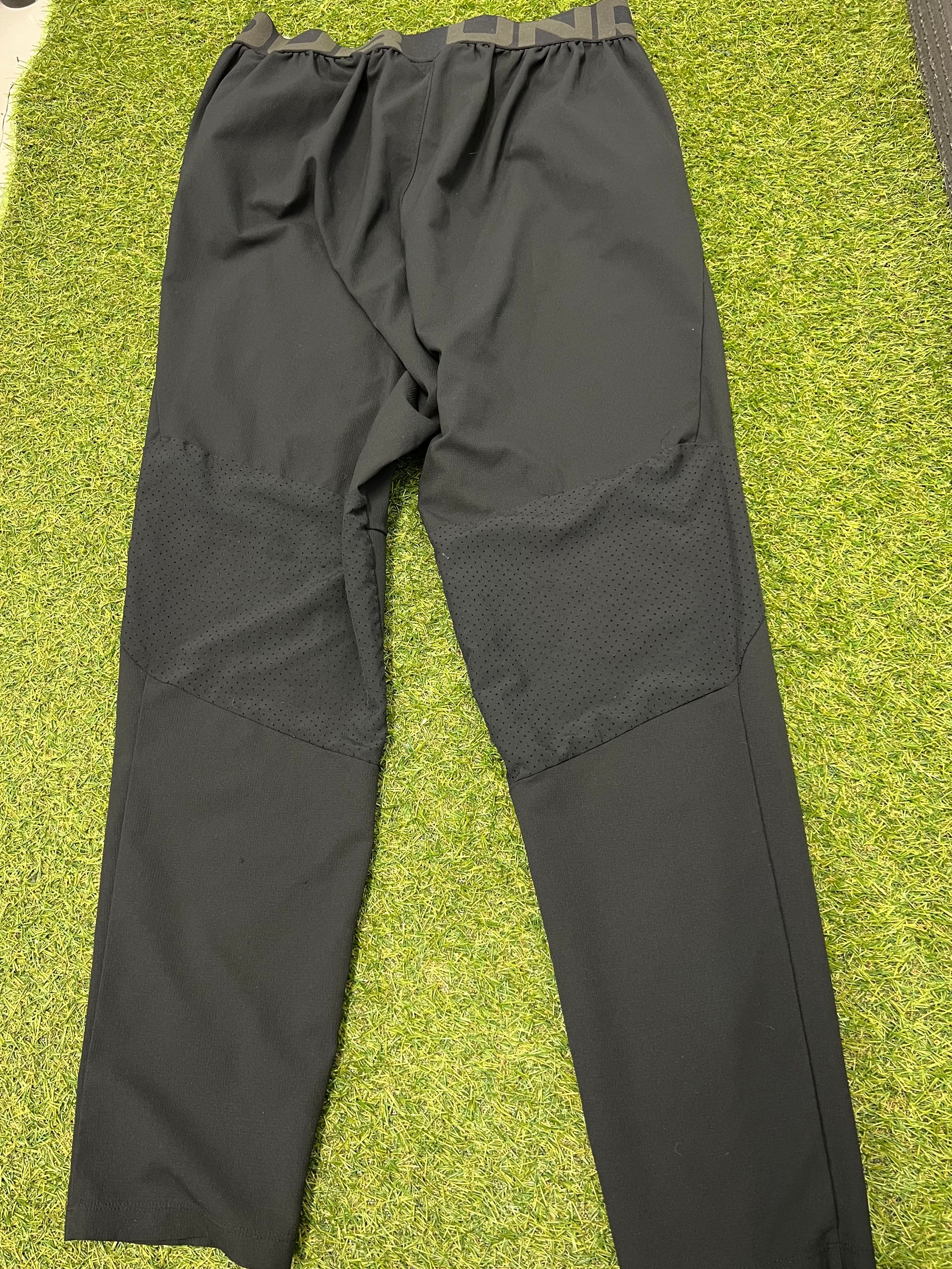 Back view of men’s Under Armour black fitted leggings showing breathable mesh panels