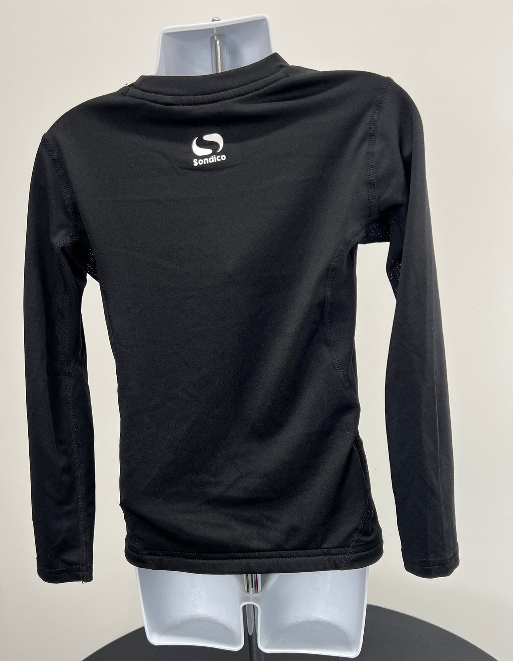 Back view of black kids Sondico base layer long sleeve top showing white logo on upper back